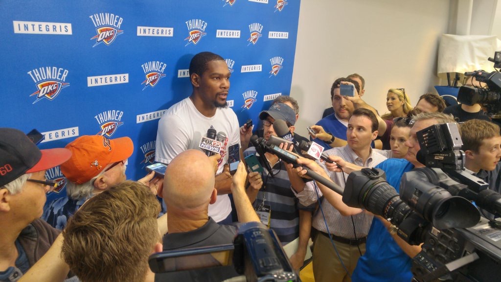 Thunder forward Kevin Durant is surrounded by reporters and cameras after a recent OKC practice session.