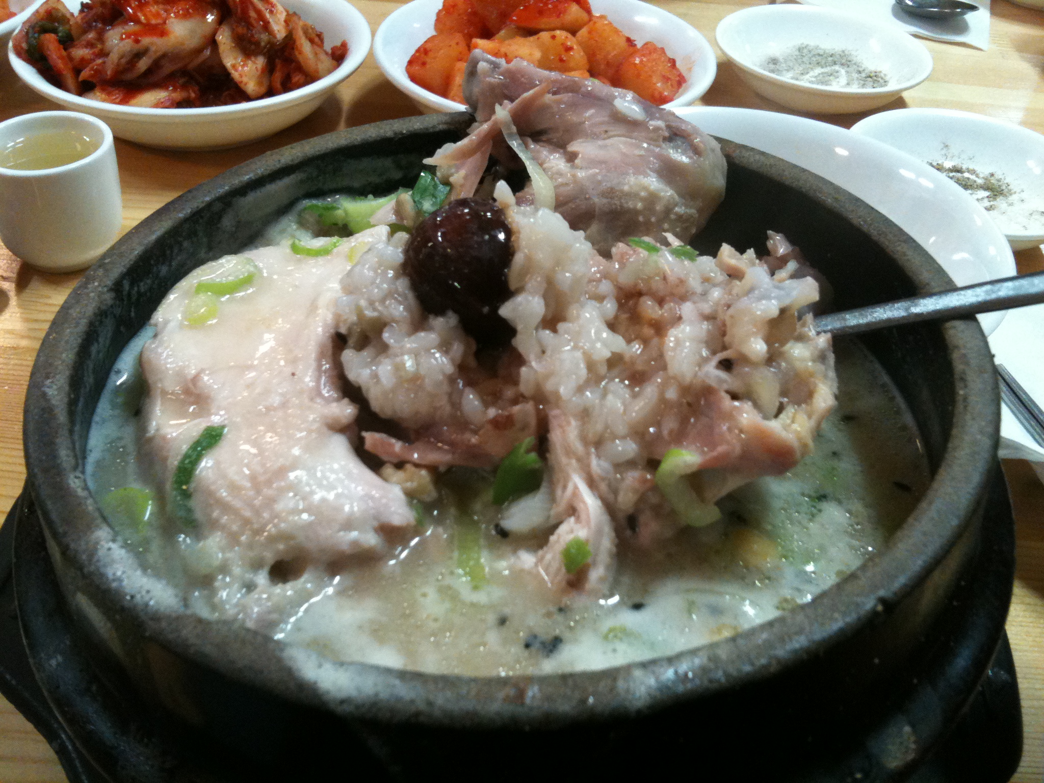 You dig in to get the delicious sticky rice full of flavour infused from the garlic, garlic, a date, chestnut, ginkgo and stem of whole ginseng. When you eat it, dip the chicken meat into a mixture of the sea-salt and black pepper you can make in the little side plate. 