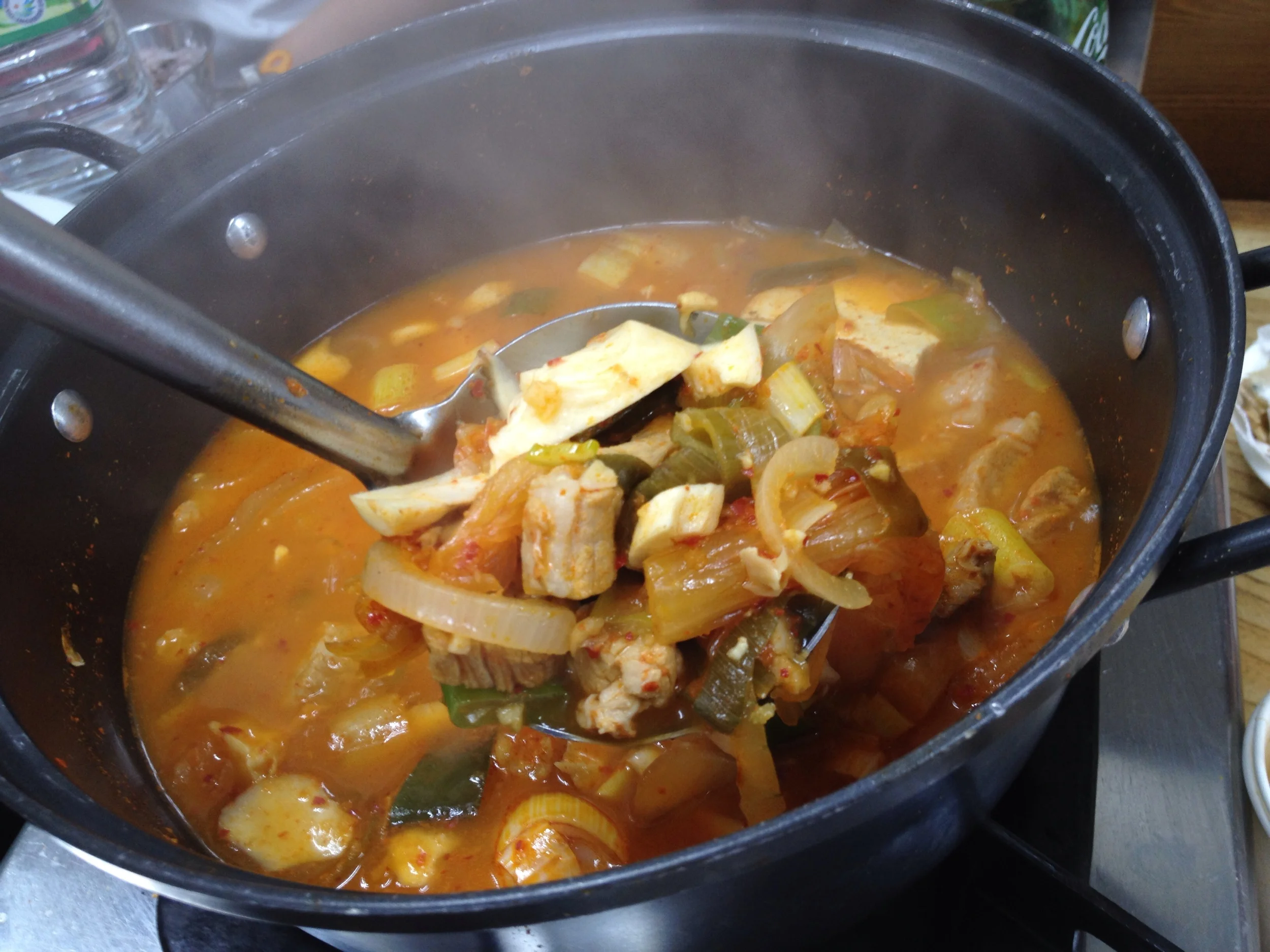 은주정 김치찌개 (EunJooJung Kimchi Jiggae). Hearty portion of chopped up 3-layer pork belly meat, kimchi, tofu, onions and green onions in a broth that is savoury, spicy but not too spicy and has a great flavour to it! At lunch, the kimchi jiggae is the only option on the menu (7000won). If you go after 5pm, you have to get the samgyupsal (3-layer pork bbq) along with the kimchi jiggae (10 000won). You don't even have to order - when you sit down, they will just bring it to you! You can add an order of rice if you would like. 