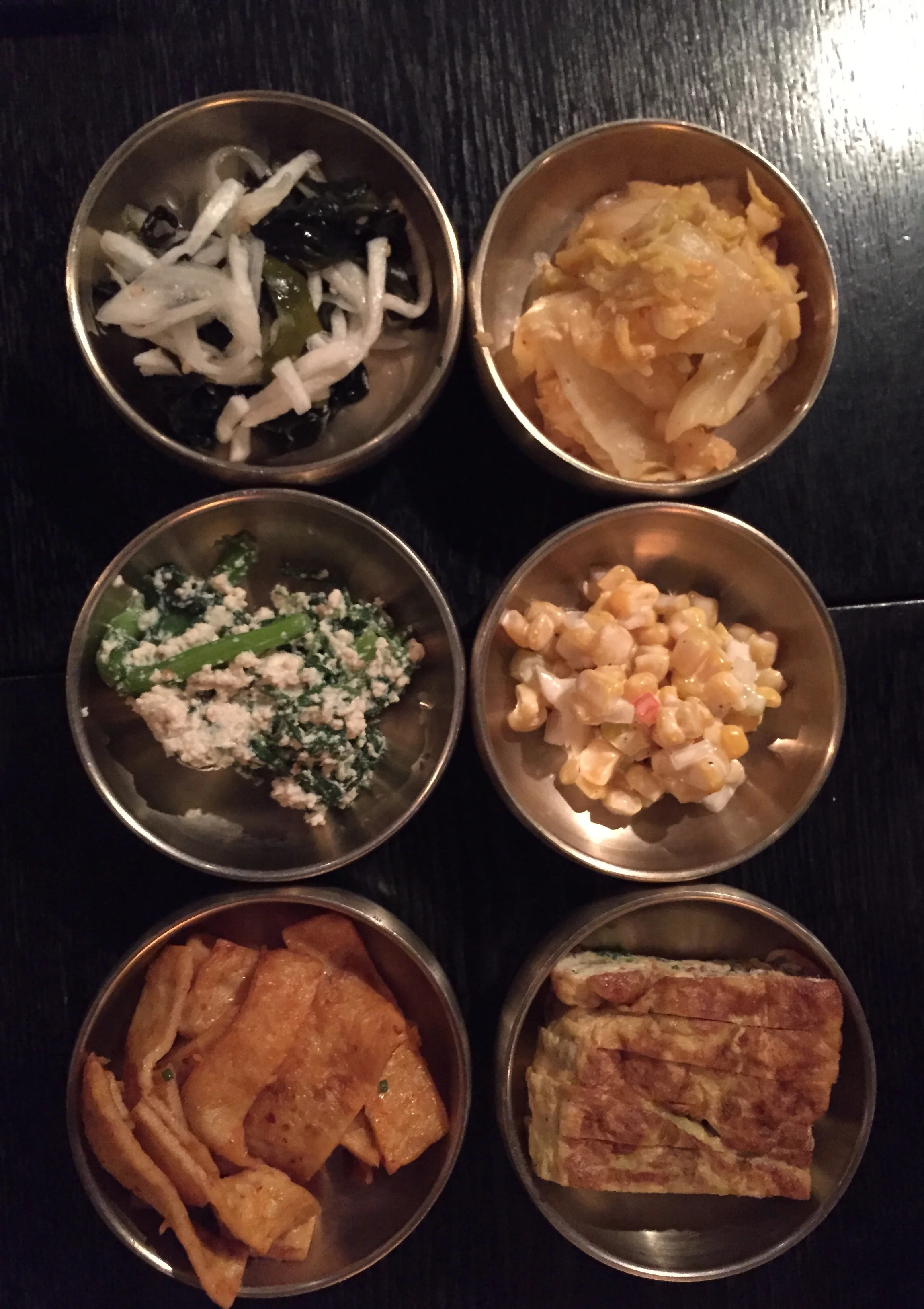 The 반찬 (banchan). Free refillable side dishes that come with all meals. Nice selection of seaweed in vinegar, whie kimchi, crown daisy vegetable in soft tofu, corn in mayo, fish cakes and egg omelette. 