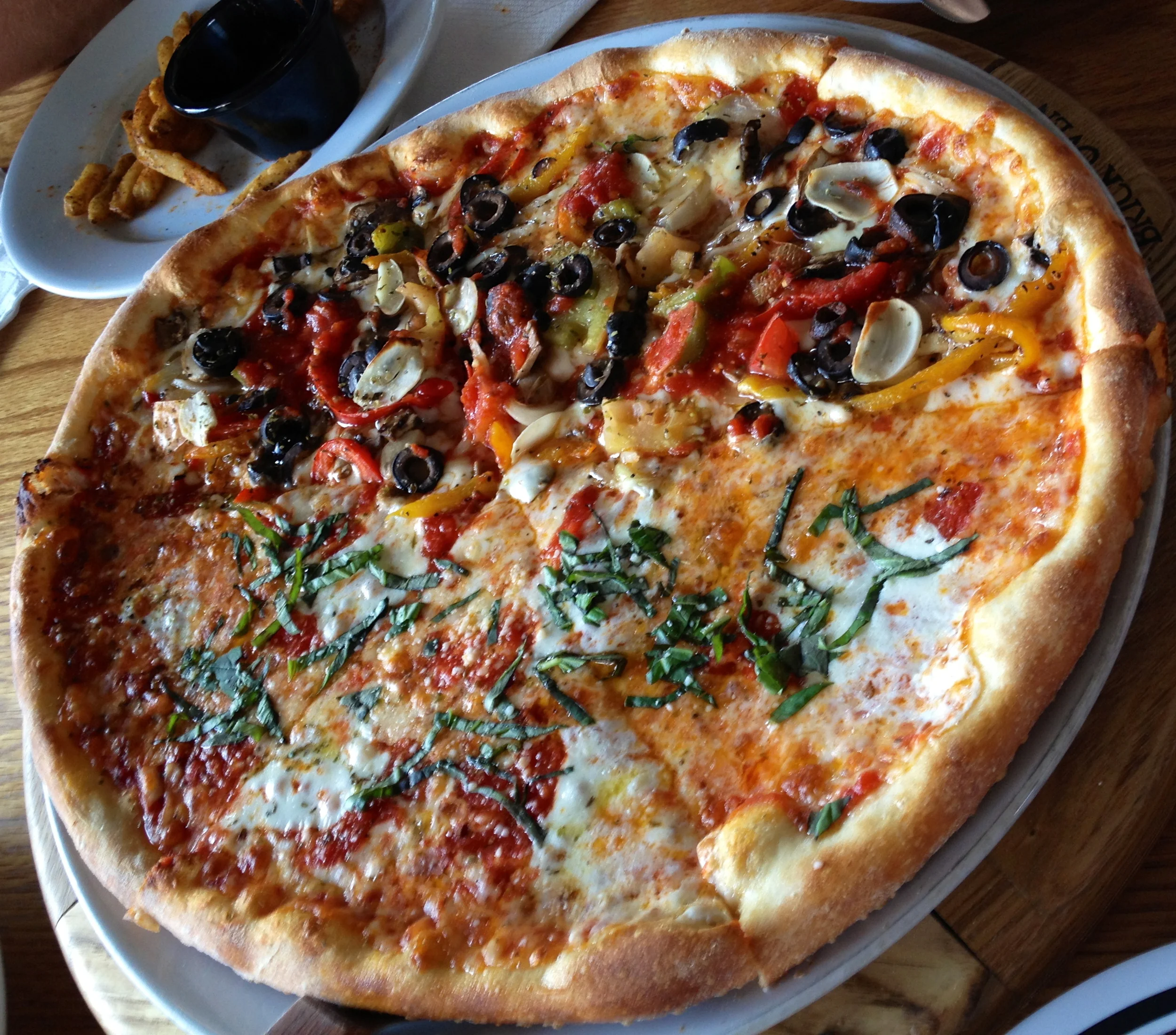 Half Margherita Caprese and Half Vegetarian: "Bell peppers, mushrooms, onions, black olives, tomatoes, garlic, mozzarella and pizza sauce." The Margherita was excellent as always. I thought the Vegetarian had a few too many toppings, so the crust on it actually got a bit soggy and it was too much. 