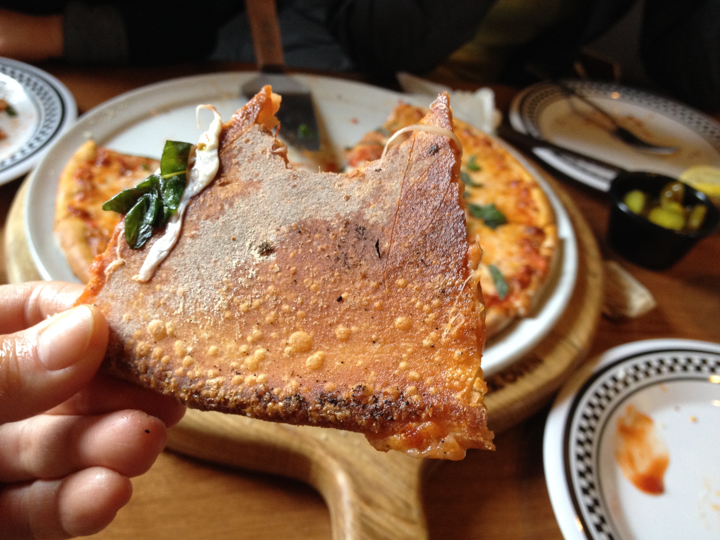 The bottom of the crust is nicely bubbled which shows how quickly it cooked at a high temperature. I normally leave crusts behind, but these are so crispy, I ate them all up!