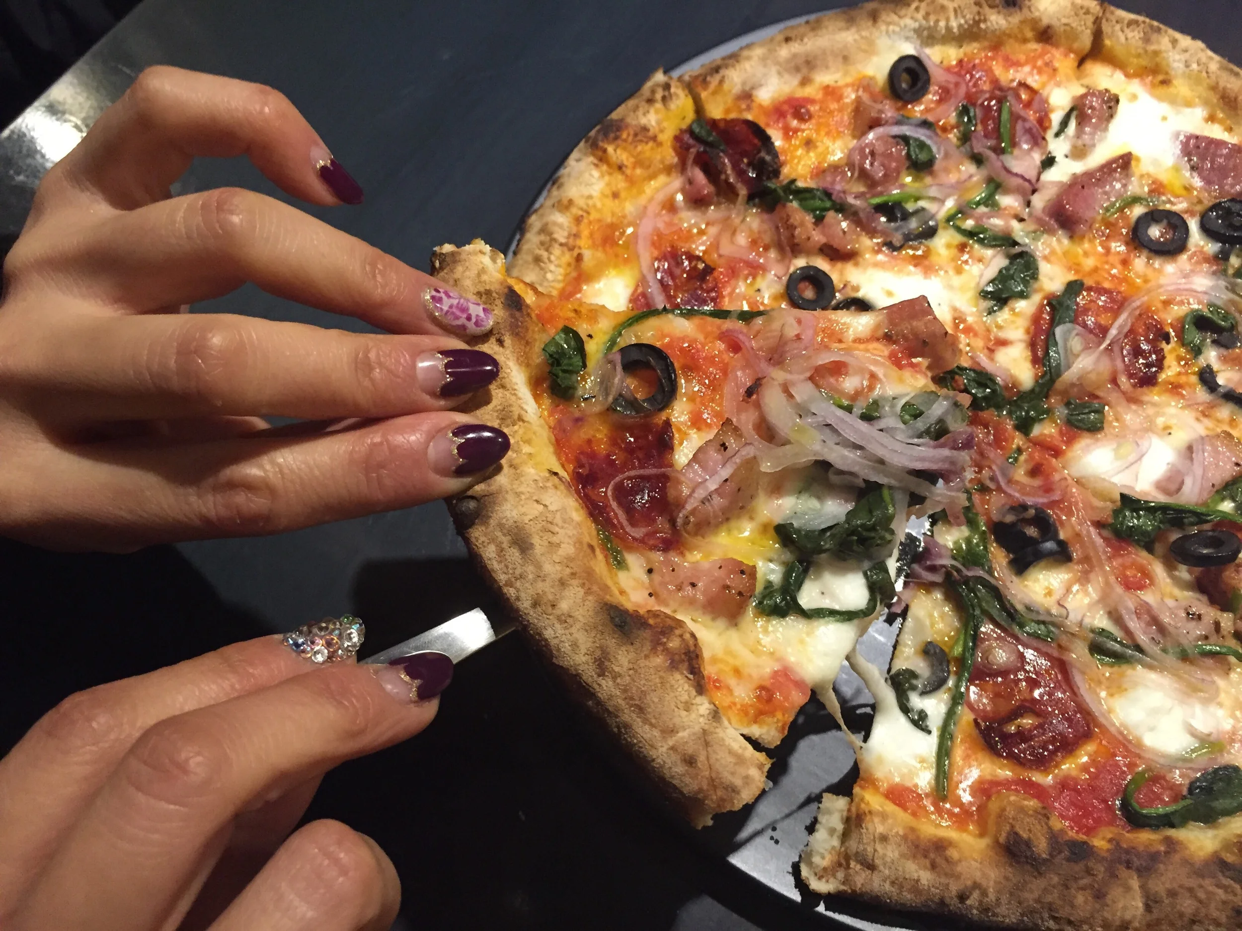 Beautiful nails of owner at @CocoLounge modeling a slice of pie! Neapolitan pizza is a type of pizza that originated in Naples, Italy.