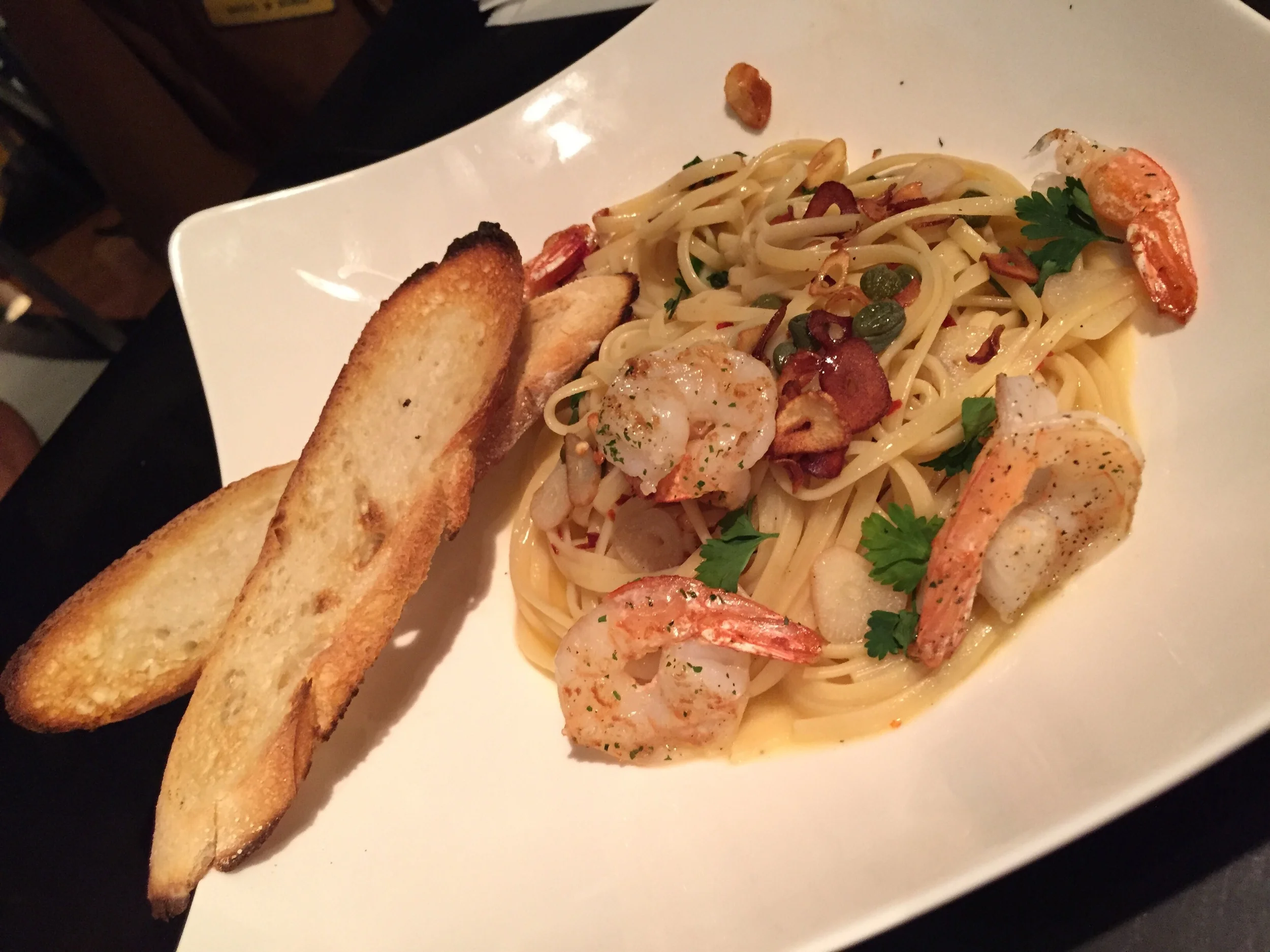 GARLIC SHRIMP LINGUINE (16 000won) - "Sauteed shrimp and linguine with capers in garlic lemon olive oil. This dish is flavourful as well, but wasn't my favourite dish - but we did order it at the end and maybe I was too stuffed at this point to fully enjoy it! If you are looking for something more hearty and filling, this is tasty and will definitely fill you up though! I picked out the shrimp and the sauce was good to soak up with the crispy flat baguette. 