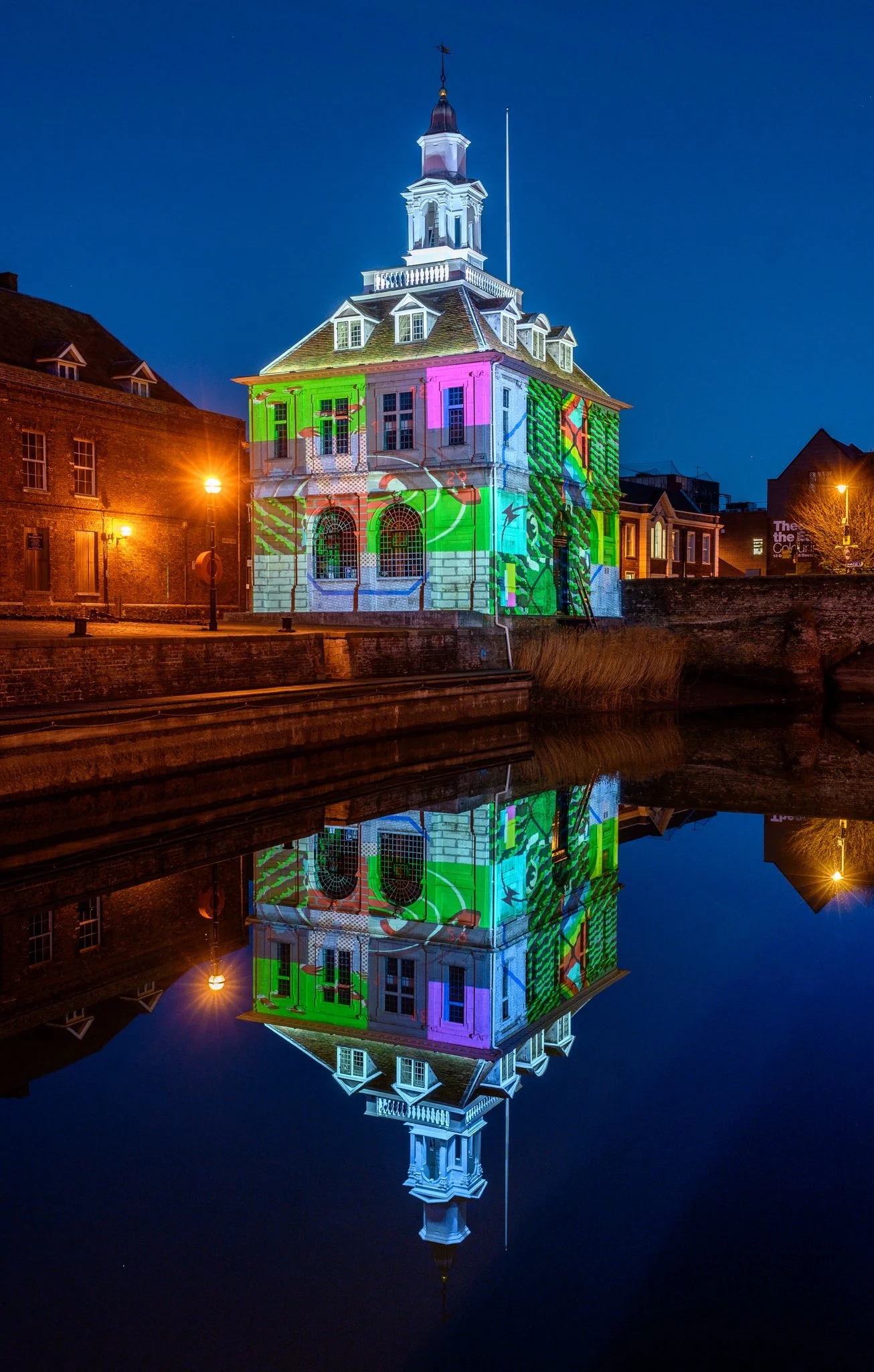 The Custom House by Joe Magee, December 2018 The Custom House is an artwork by Joe Magee. It was commissioned by Cambridge-based arts organisation Collusion to form part of their Reveal project - a series of artworks and performances in Kings Lynn (England). The large scale projection onto the 17th Century harbourside building sees fragmented images randomly altering. Visitors can interact using their smart phones to change and resolve the images so that the building becomes like a giant Rubik’s Cube. Joe’s images explore the themes of Reveal - soul searching about migration, borders and brexit in the English heartlands. The interactivity and coding for the artwork was developed by cutting edge digital programmer Pi & Mash . Digital coding: Pete Cleary @ Pi & Mash. Produced by Marcus Romer and Simon Poulter. Executive Producers: Simon Poulter, Rachel Drury. Creative technologist: Richard Hall. REVEAL has been developed by the Borough Council of West Norfolk and King’s Lynn working with Collusion. Additionally, the project has been funded by Arts Council England, Norfolk County Council, Discover King’s Lynn and The Business Board. PHOTO CREDIT: Matthew Usher