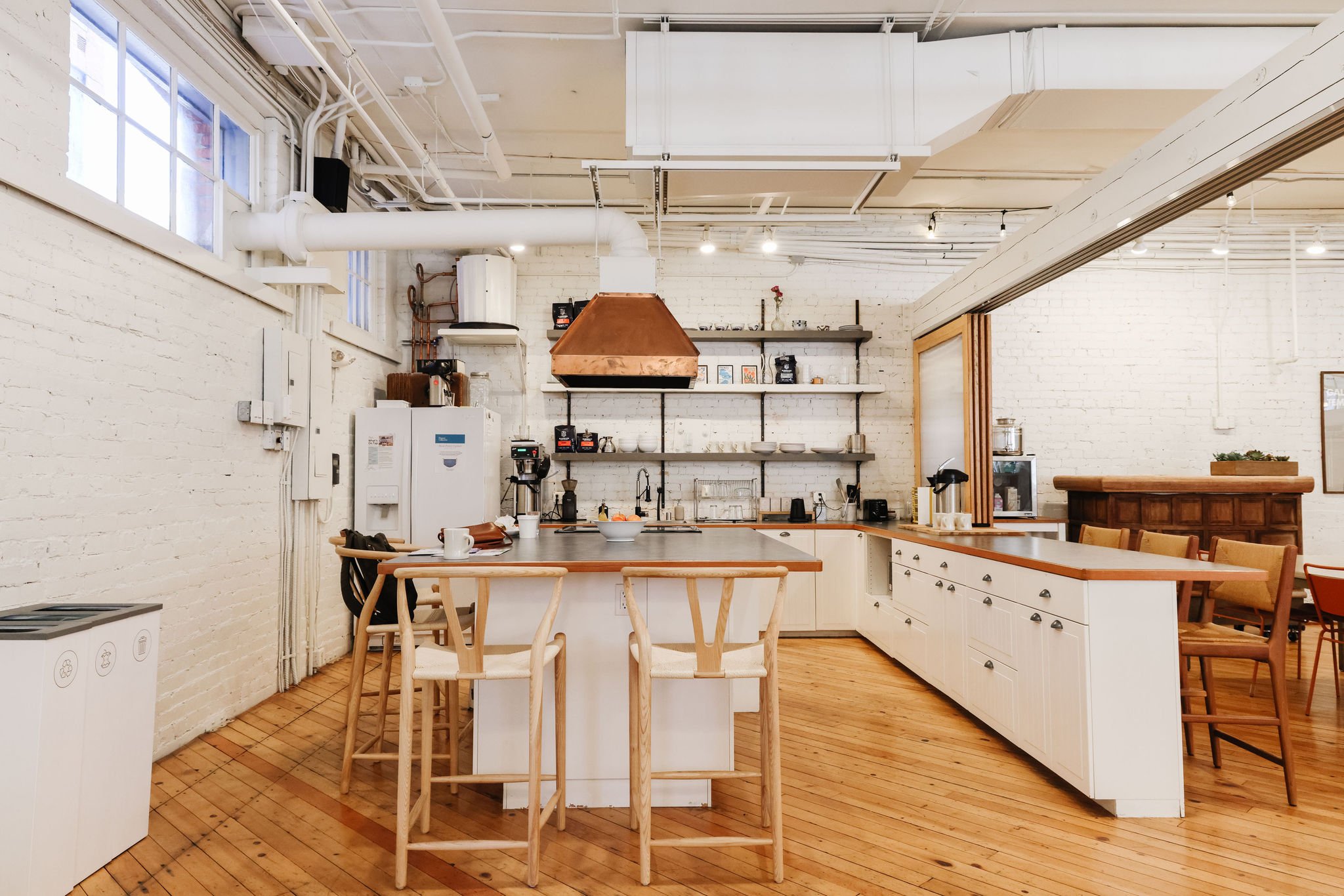  A coworking kitchen with bar stools around an island 