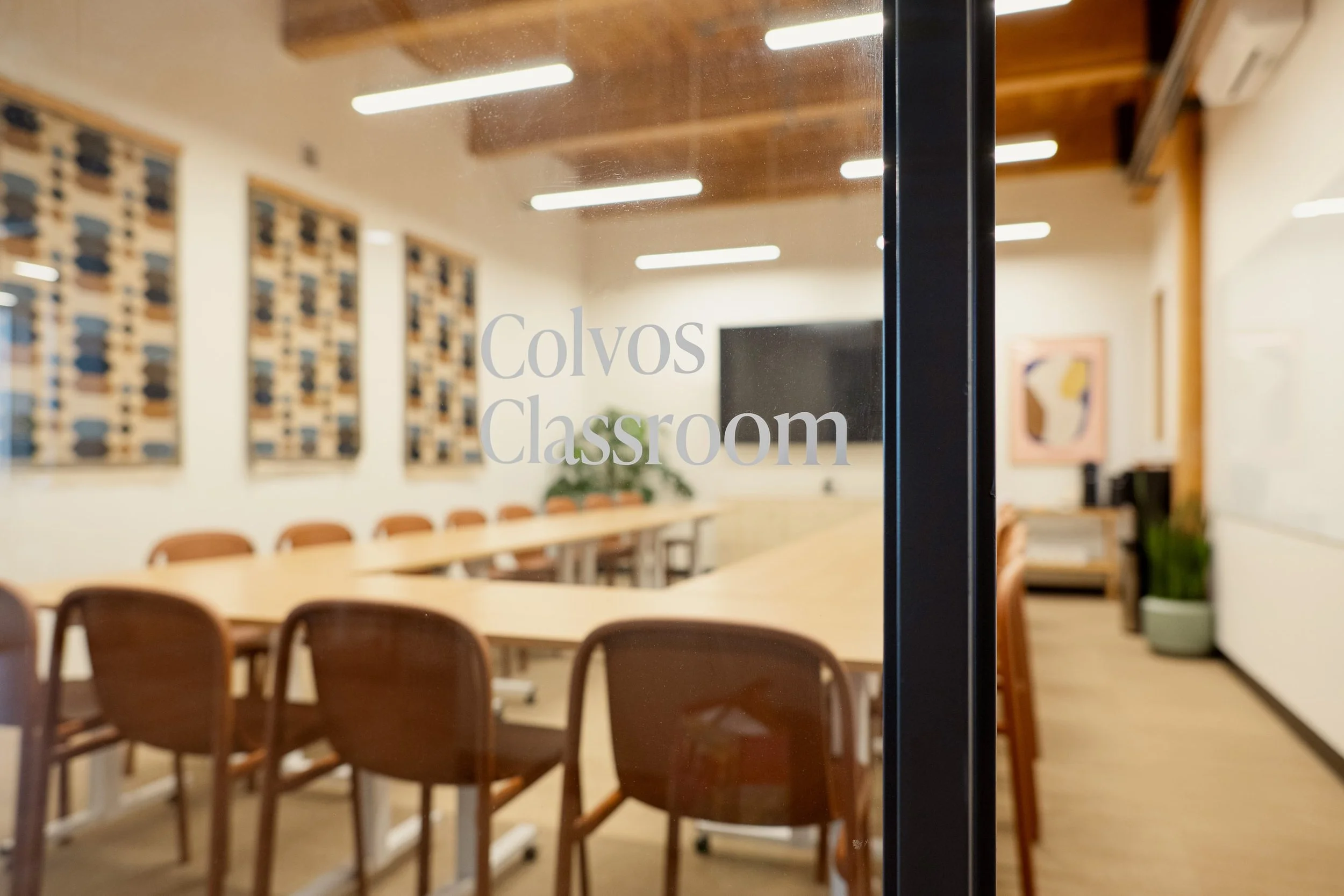 An unfocused view of a corporate classroom with red chairs
