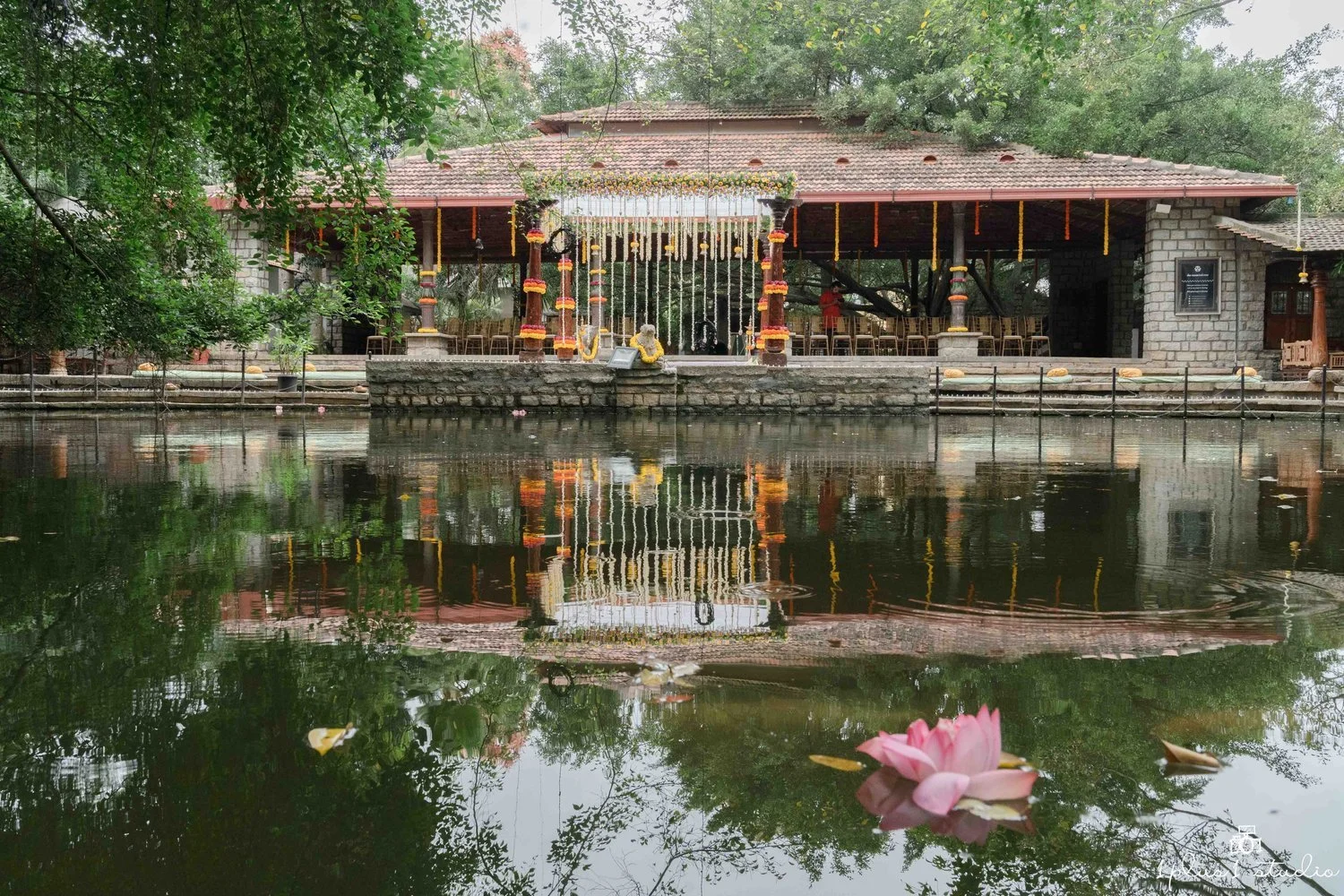 https://images.squarespace-cdn.com/content/v1/52ed3507e4b041396187d22b/1667469549169-ZU0ASZJ1MWUR8ILXH0KW/Pond%2BPavilionTamarind%2BTree%2BBangalore%2BWedding%2B3.jpeg