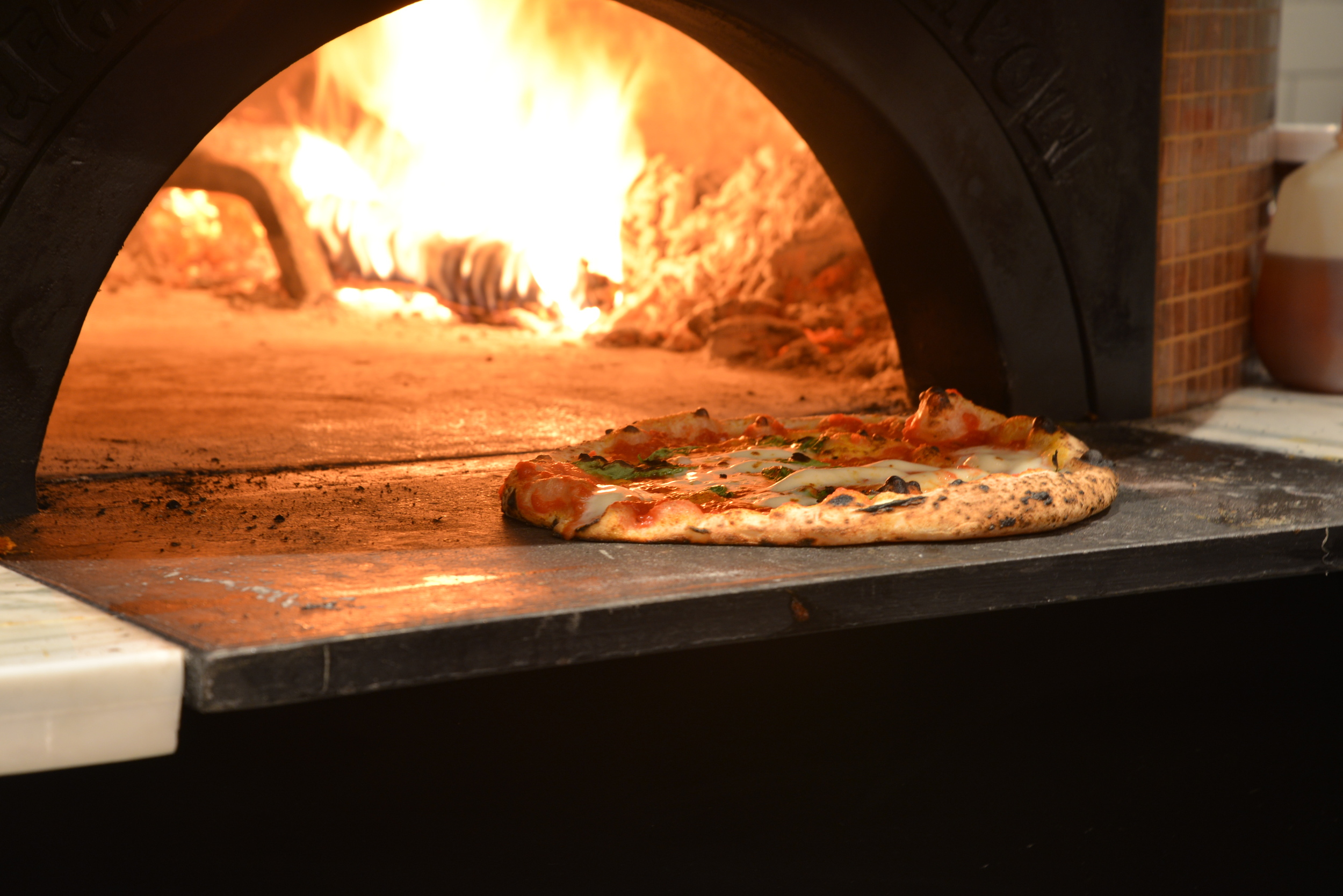   A wood-fired oven that hits nearly 1,000 degrees cooks Settebello's pizzas fast./ HEATHER GOLDIN, STAFF&nbsp;  