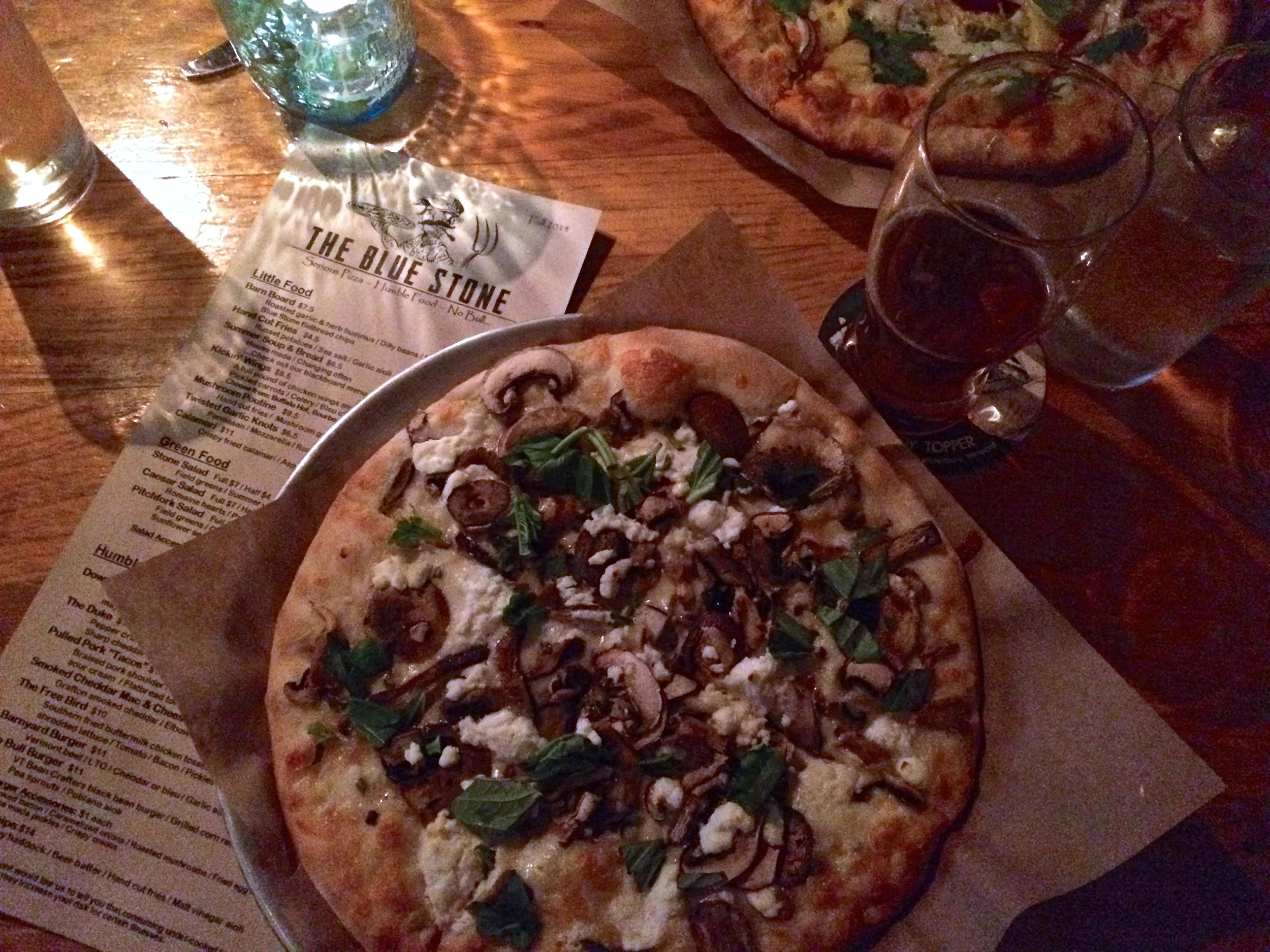 The Blue Stone Pizzeria in Waterbury, VT. Local beer, local produce, fresh wood-fired pizza... perfection. There's three different kinds of mushrooms, local goat cheese and basil on that glorious pizza! Switchback to wash it all down.