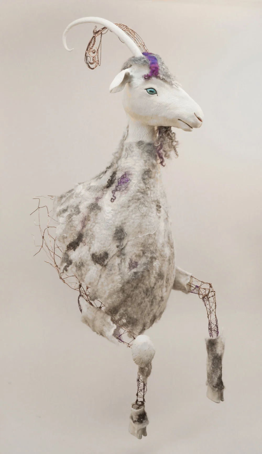 Yep, it’s a goat. It’s actually a life-size goat. Well, half of one. Constructed of clay (head, one horn, hooves, one knee), copper wire frame and wire wrapped horn, felted wool hide, forlock & beard.