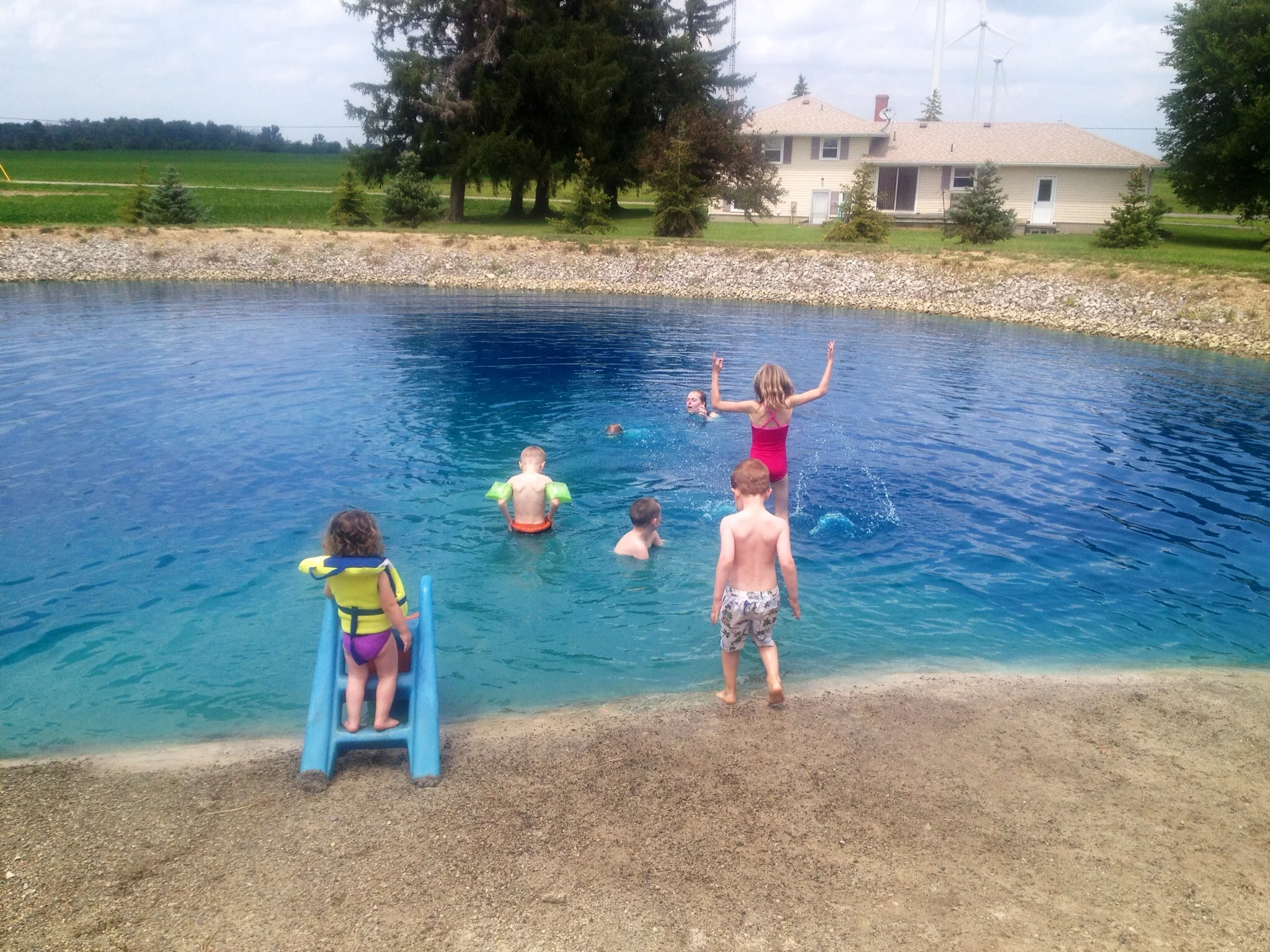 Apparently it's a thing in Ohio to "dig a pond". Much like an in-ground pool, you add chemicals to keep them clean and have a pump and all. We have seen many of these in Ohio so far and a good many are just as blue as this one. It's truly a strange and wonderfully fun anomaly.