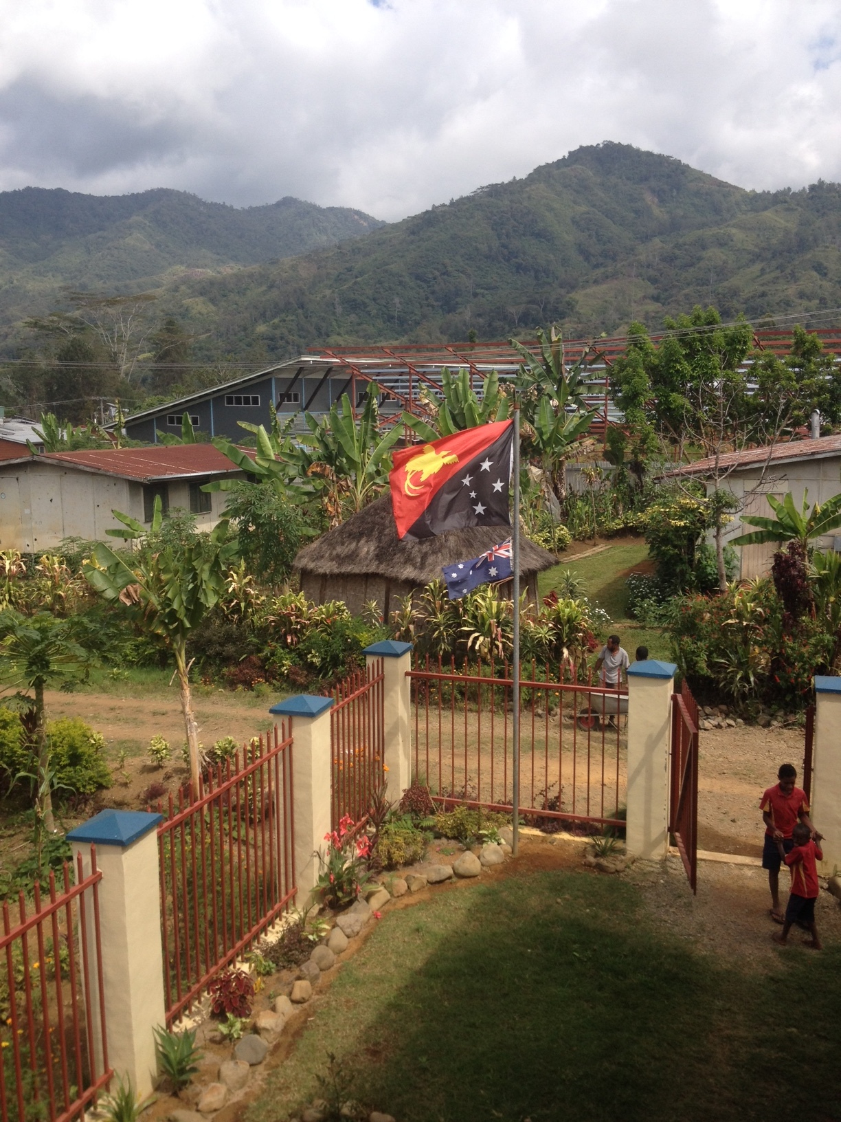  From the school stairway, looking back toward the hospital, with the PNG flag blowing. 