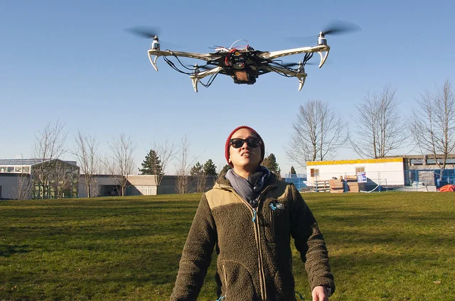 A student watches a recreational drone mid-flight. Image credit:&nbsp;Simon Fraser University