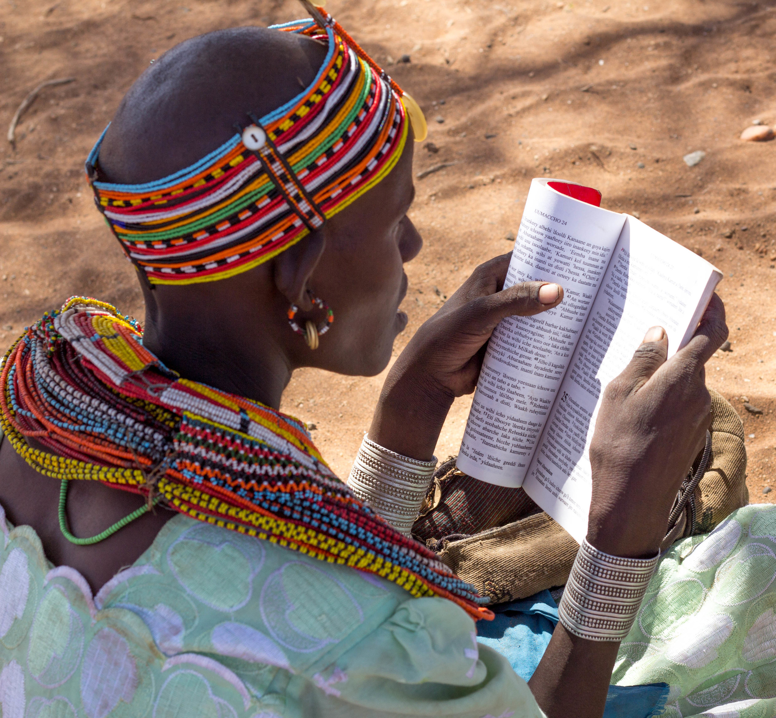 Previously illiterate, this women delights in being able to read.jpg