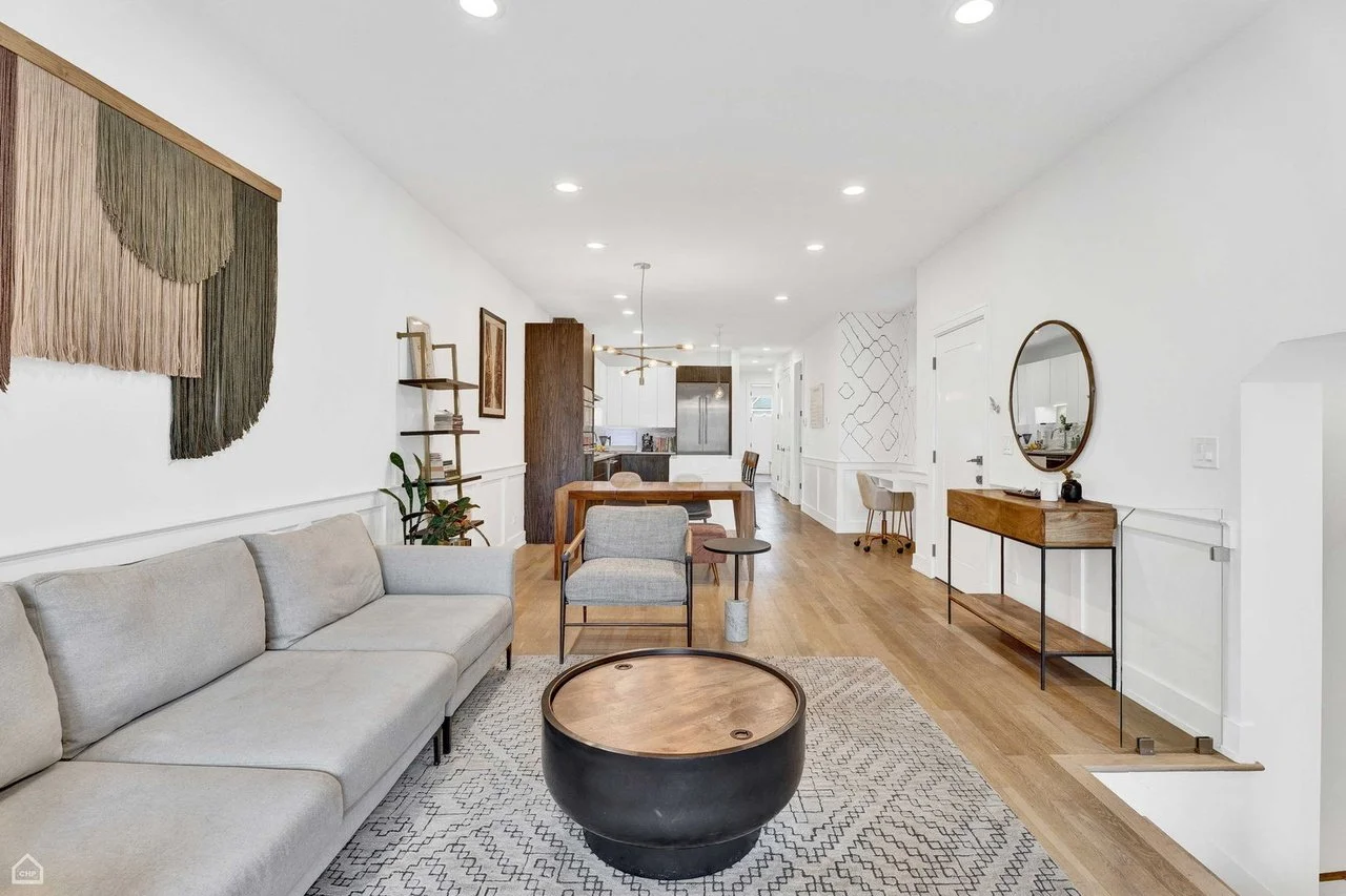  This layered, light-filled home reflects a thoughtful blend of form and function. This full-furnishing project included sourcing furniture, lighting, wallpaper, and accessories for the living room, dining area, and primary suite. A palette of natura