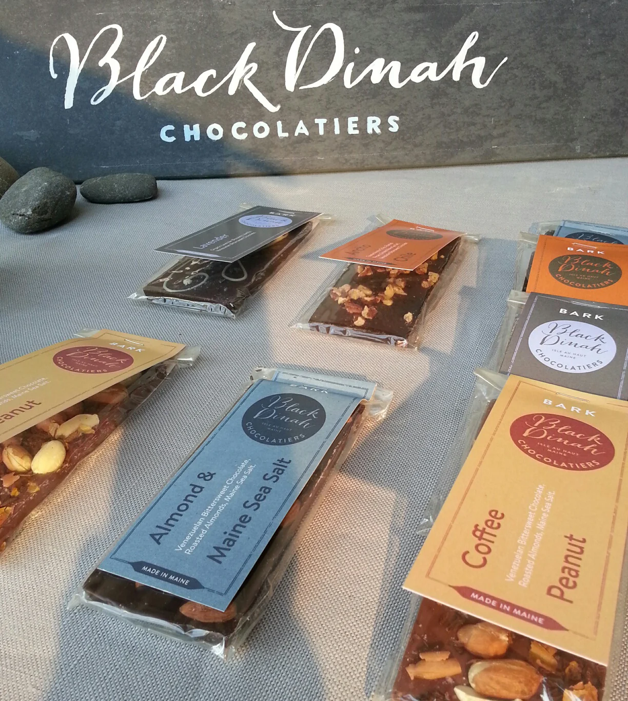 Close up of chocolate bark labels and painted slate sign for the booth.
