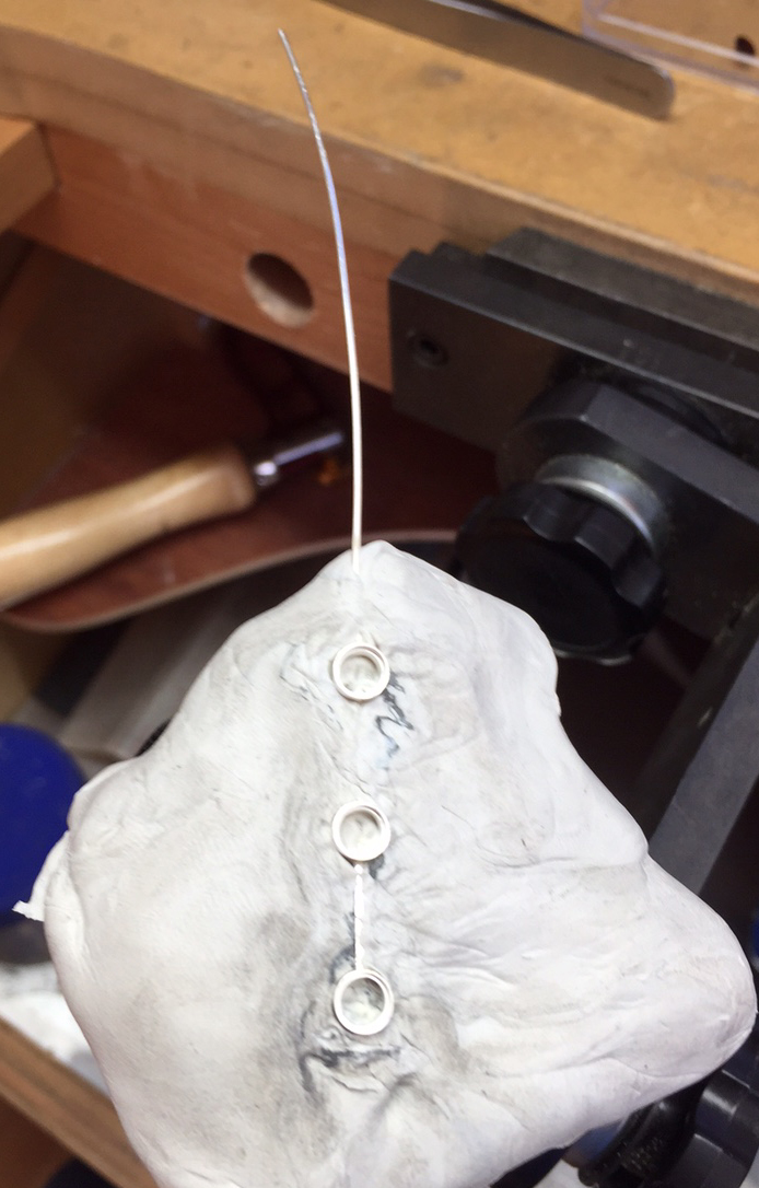earring embedded into jettset, ready for stone setting.
