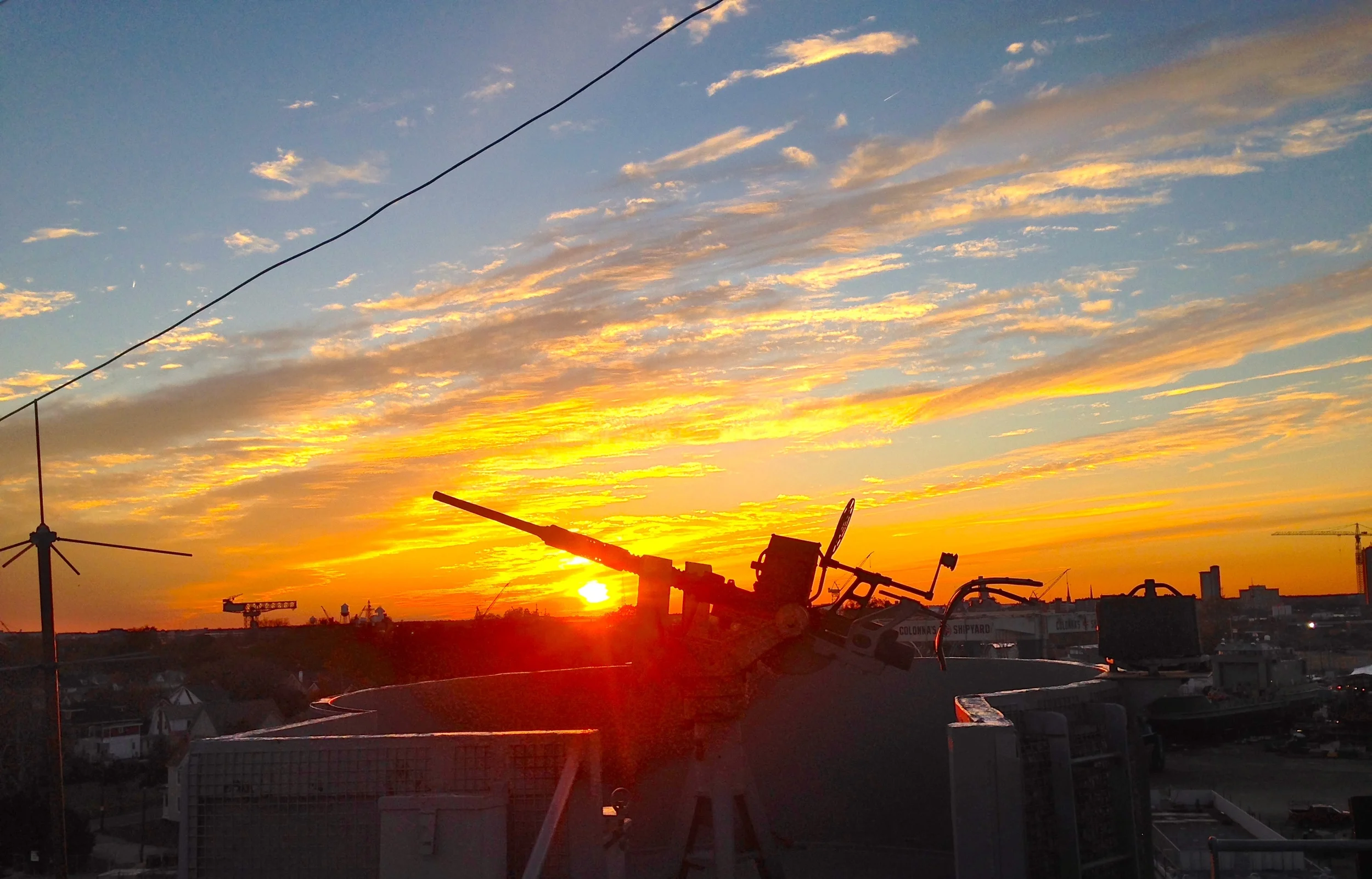 The end of the day brings a regular "debriefing" with the crew including a great view of the sunset over Portsmouth and Norfolk VA. On the Horizon you can see the Hammerhead Crane used in the construction of American Battleships, which we will detail in a later post!