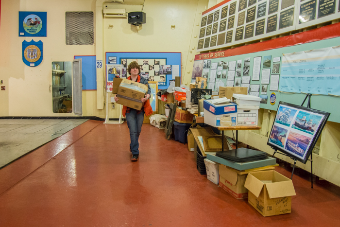 Students and crew clear out storage spaces for routine cleaning and in some cases changing out items on display. 