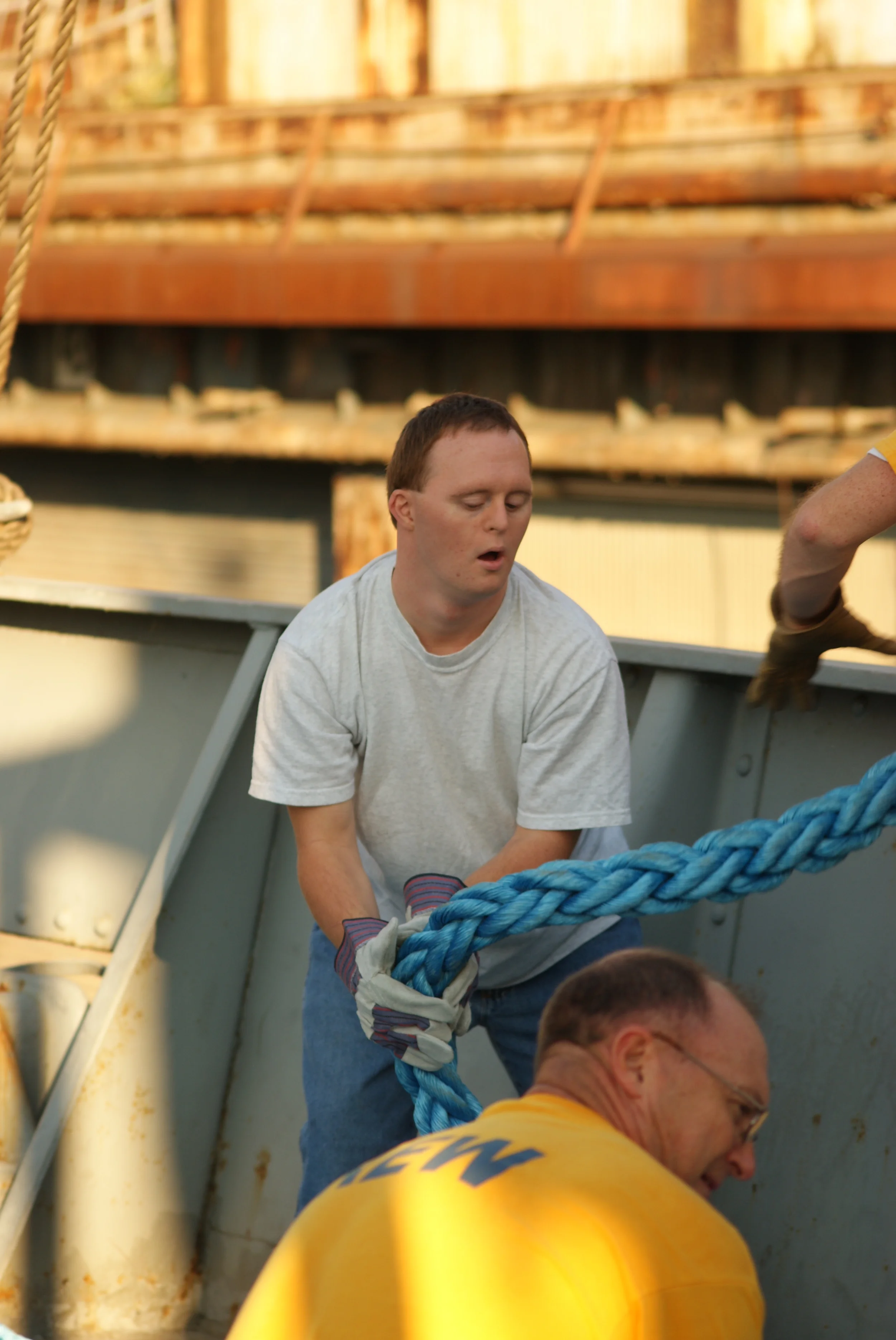 Howard (foreground) and his son Andrew (background) handling mooring lines while tying up the ship.