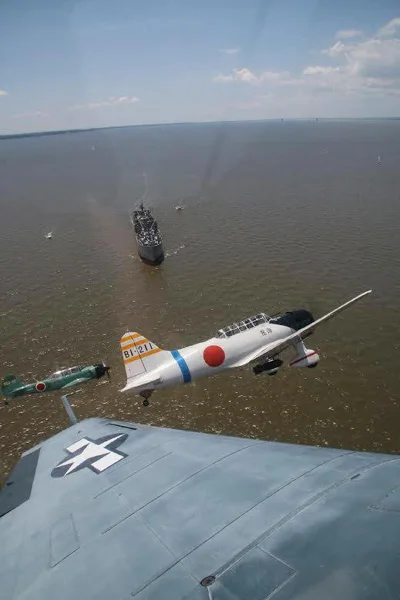 Y ou can just see the wing tip of the Avenger, She's the Boss , here as it chases the Japanese planes away from the BROWN. Photo Credit: Stephen Chapis.
