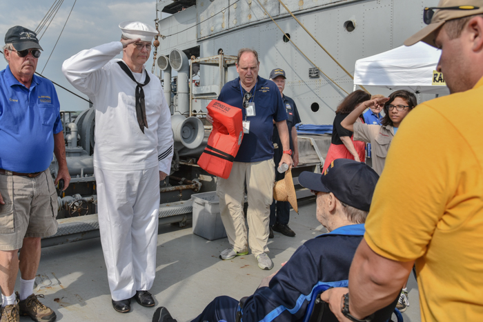 Hugh Cadzow welcomes Richard aboard on behalf of our Armed Guard Unit, accompanied by a group of Boy Scouts. (Don't worry, Ernie just got caught in the picture on his way to do his routine pre-cruise lifejacket demonstration for the passengers)