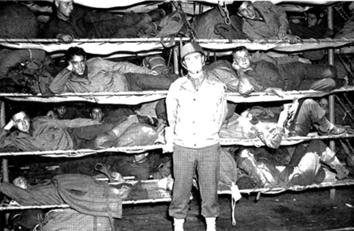 550 bunks were stacked several tiers high in some of the ships cargo holds. A galley, a mess hall and sparse sanitation facilities were also added. I can't imagine what it was like in rough seas.