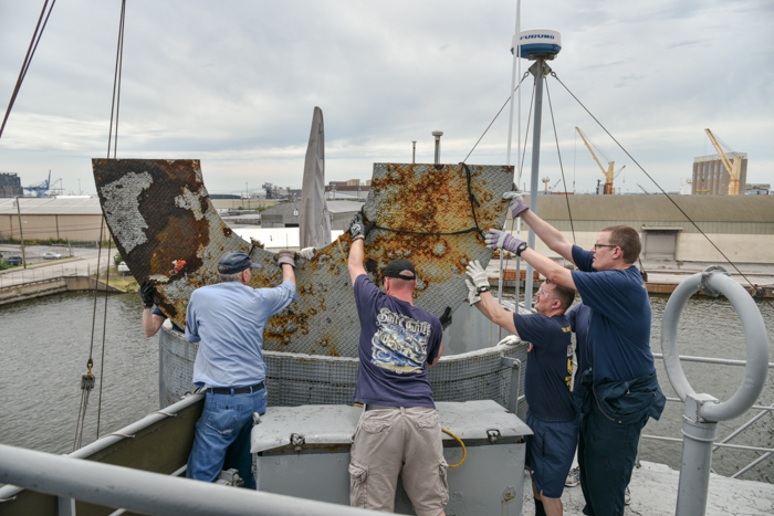 Team work is a marvelous thing and there were hands supporting the plate through the whole process. Don't for get there are 4 people inside the gun tub too.