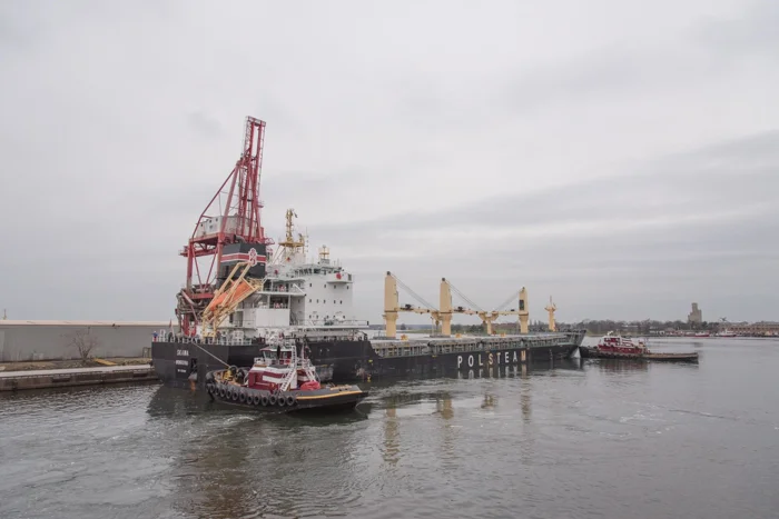The tugs will bring the very full freighters into berth. 