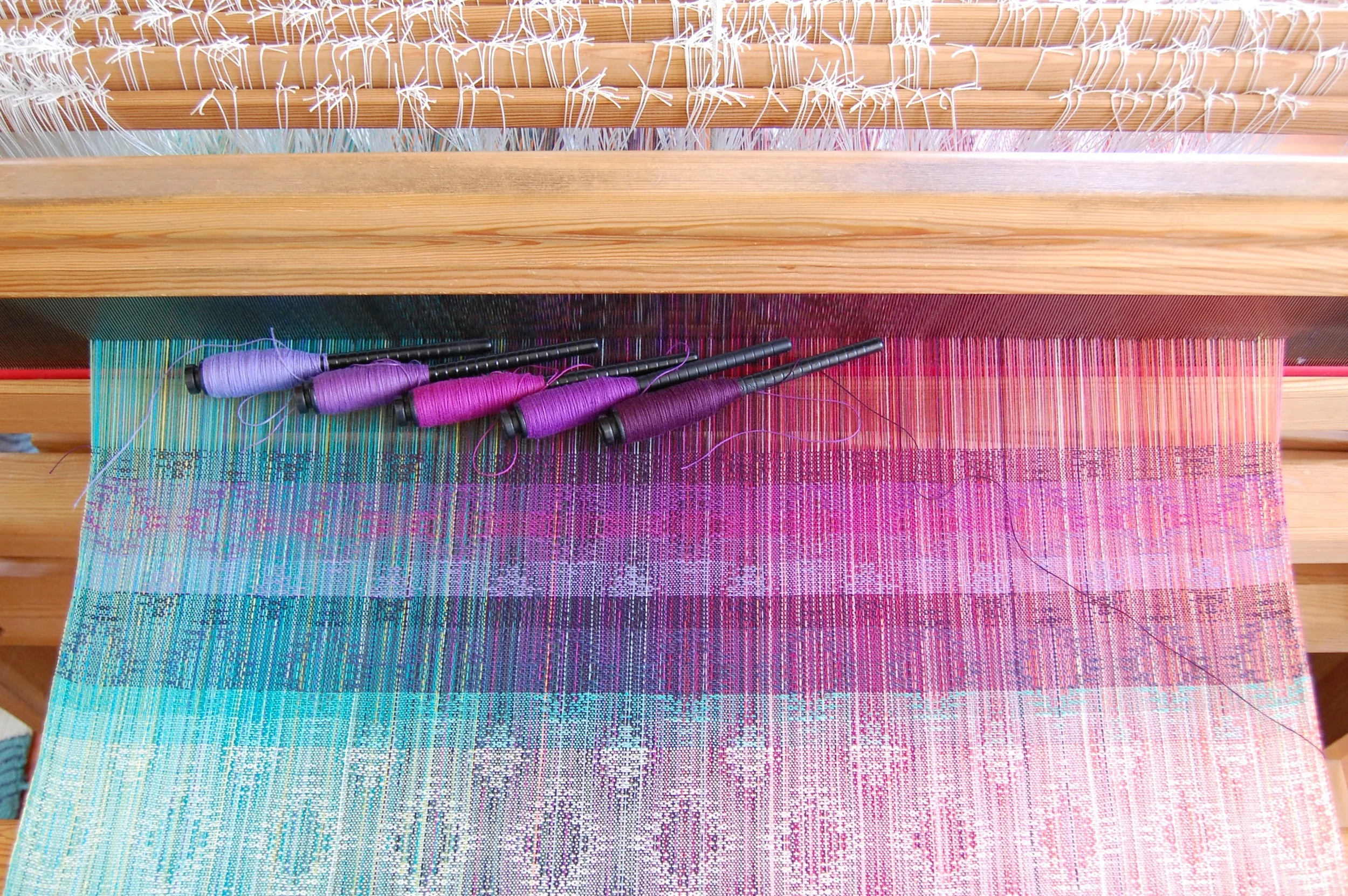 Purple cotton weft choices (top 5 stripes). The bottom stripe corresponds with the left-most pern: anemoon organic cotton, purple cotton, magenta cotton, mauve pale cotton, eggplant Egyptian cotton