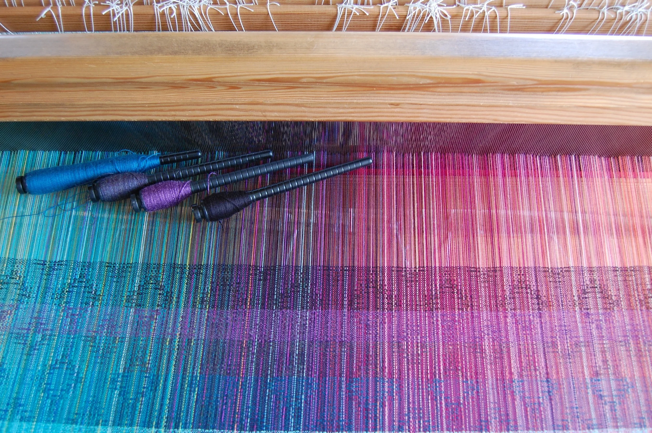 Bottom stripe corresponds to left-most pern: lapis super-wash merino lambswool, midnight super-wash merino lambswool, plum 50% merino/50% silk, Australian organic merino wool in black
