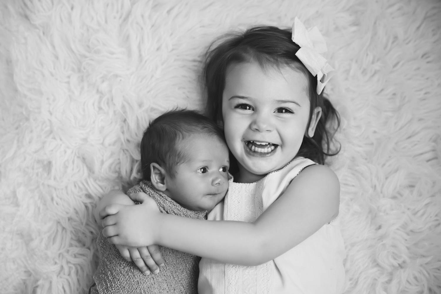 Big sister and newborn baby brother in Atlanta natural light studio