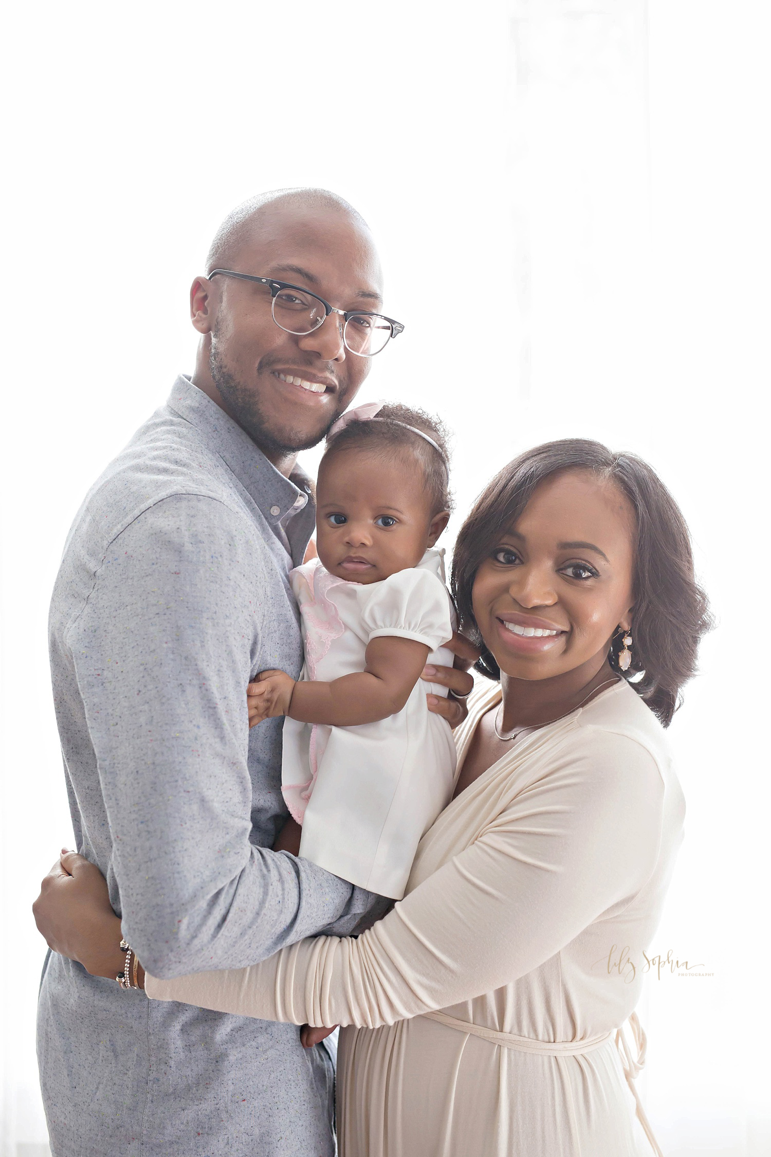 Image of an African American man and woman with their daughter held between them.&nbsp; 