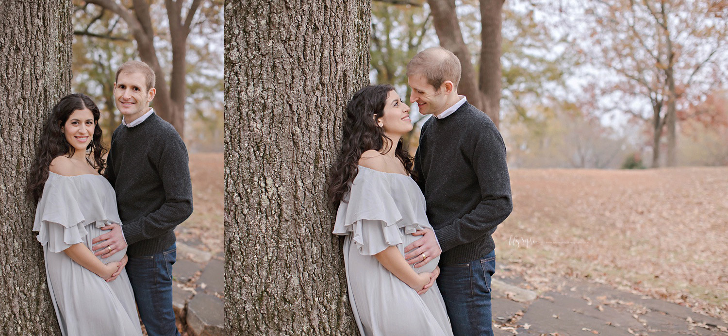 Couple pregnant with baby girl leaning against a large tree in intown Atlanta park