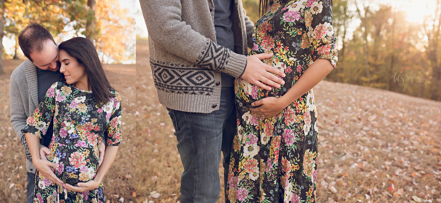  A close up photo of a pregnant woman in a floral dress with her husband caressing her pregnant belly. 