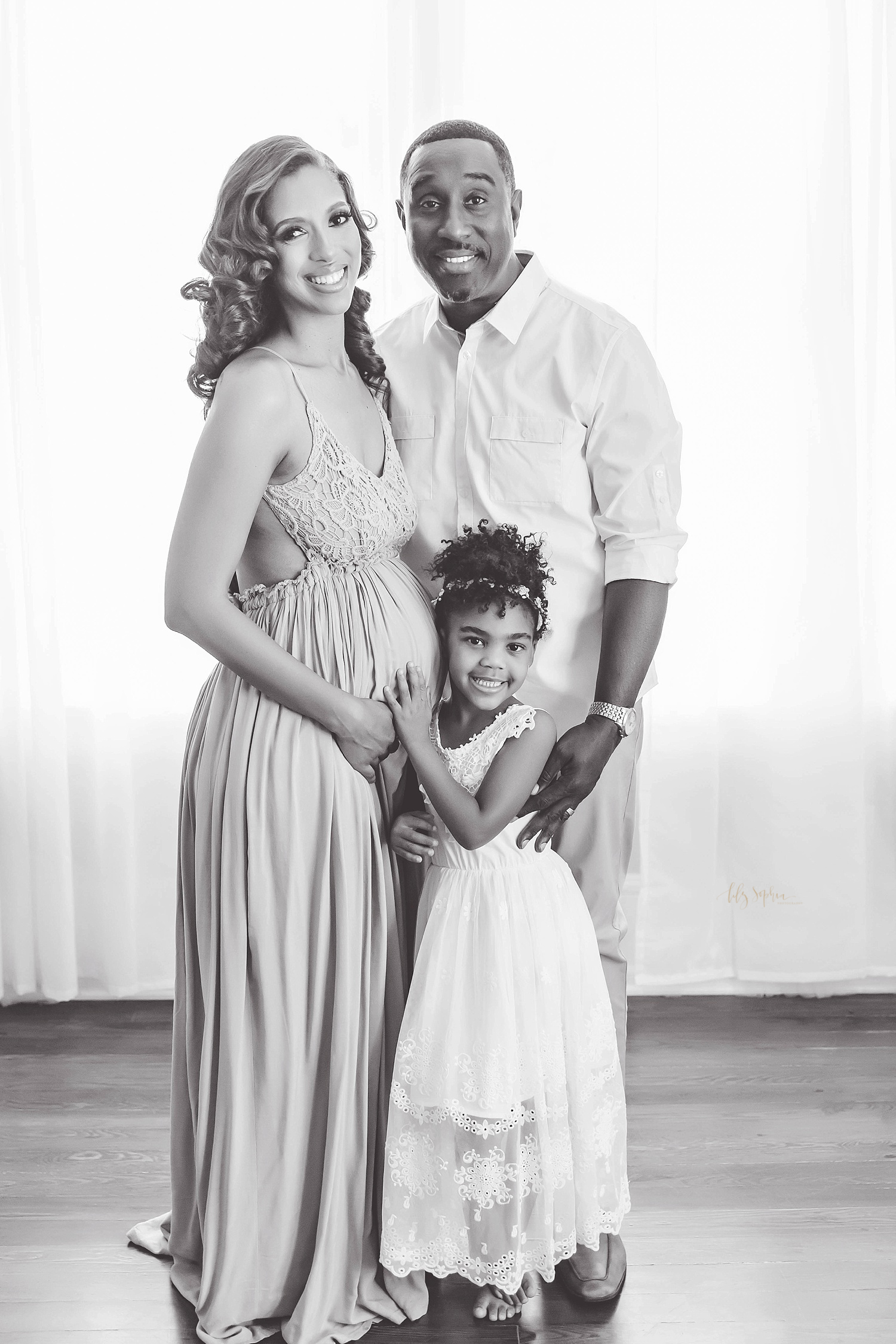 Portrait of a happy African American family taken by Lily Sophia Photography in natural light studio located in Grant Park neighborhood of Atlanta, Georgia