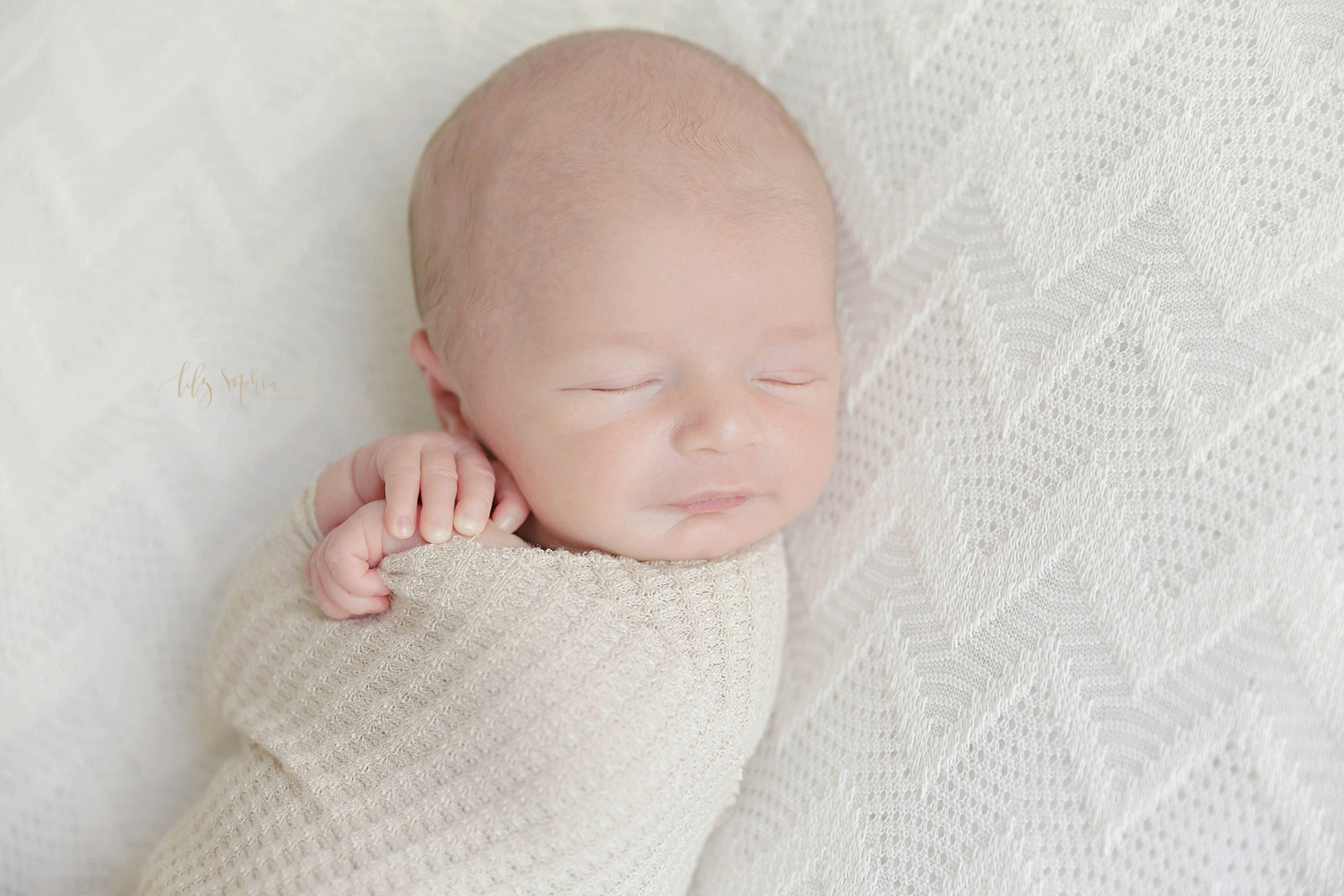  Sleeping, newborn, boy wrapped up tightly with his hands sticking out.&nbsp; 