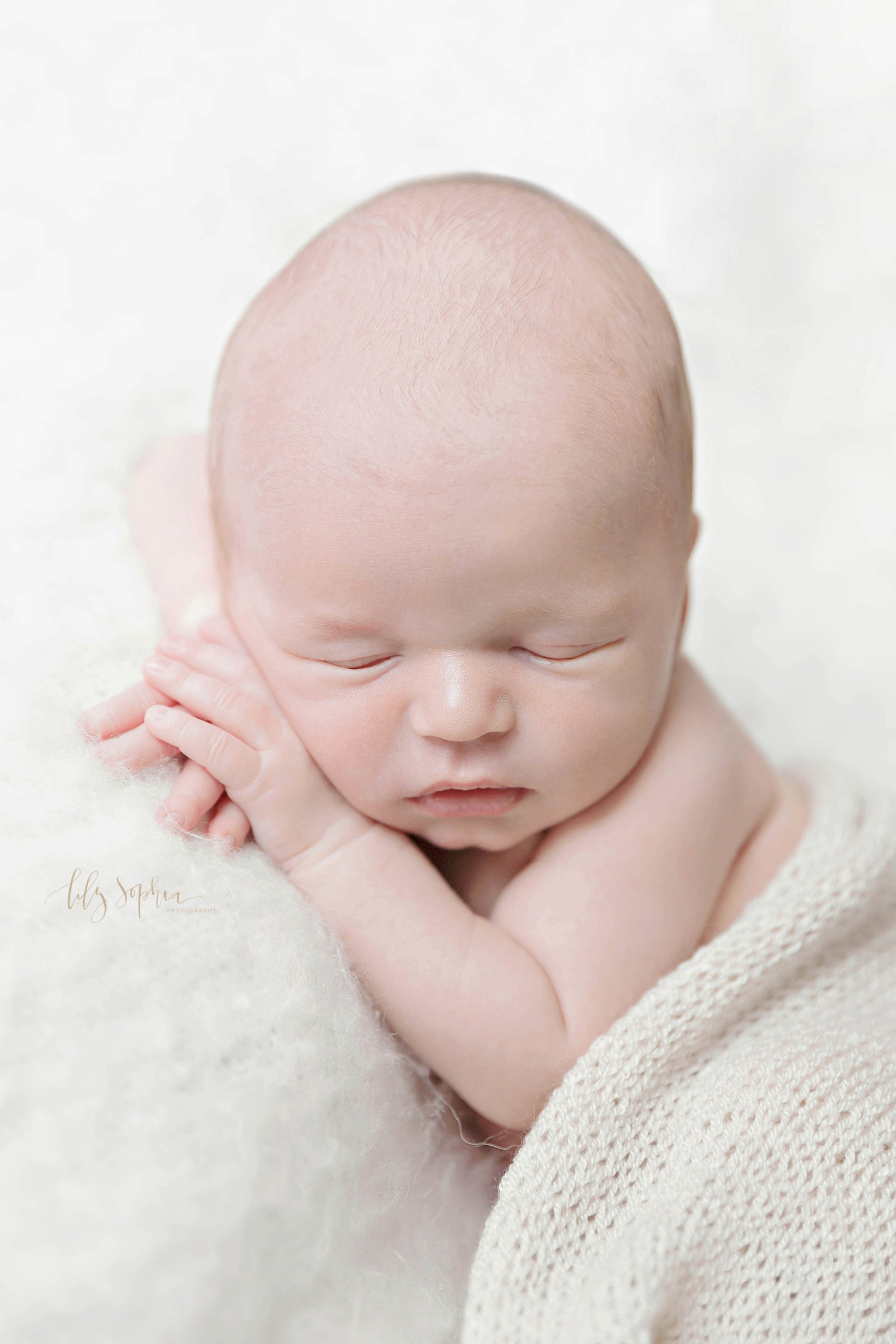  Sleeping, newborn, boy with his hands crossed under his chin, taken at Lily Sophia Photography.&nbsp; 