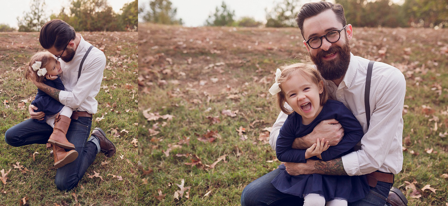  A father and daughter laughing and hugging outdoors in the fall in Atlanta. 