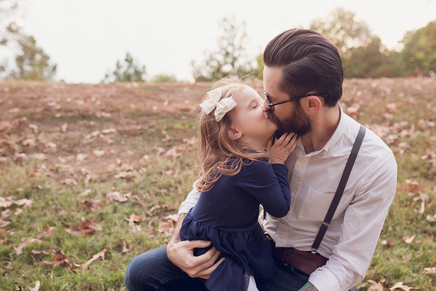  A daughter giving her daddy a kiss. 