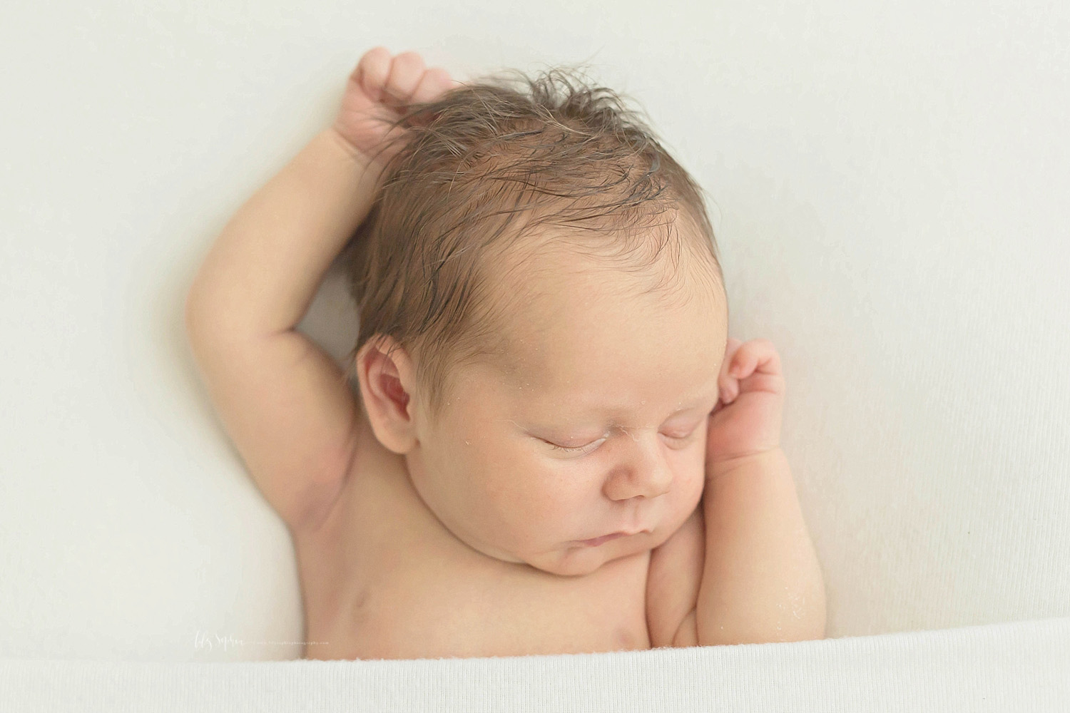  Image of baby, newborn, boy, sleeping on his back, with his hands above his head.&nbsp; 