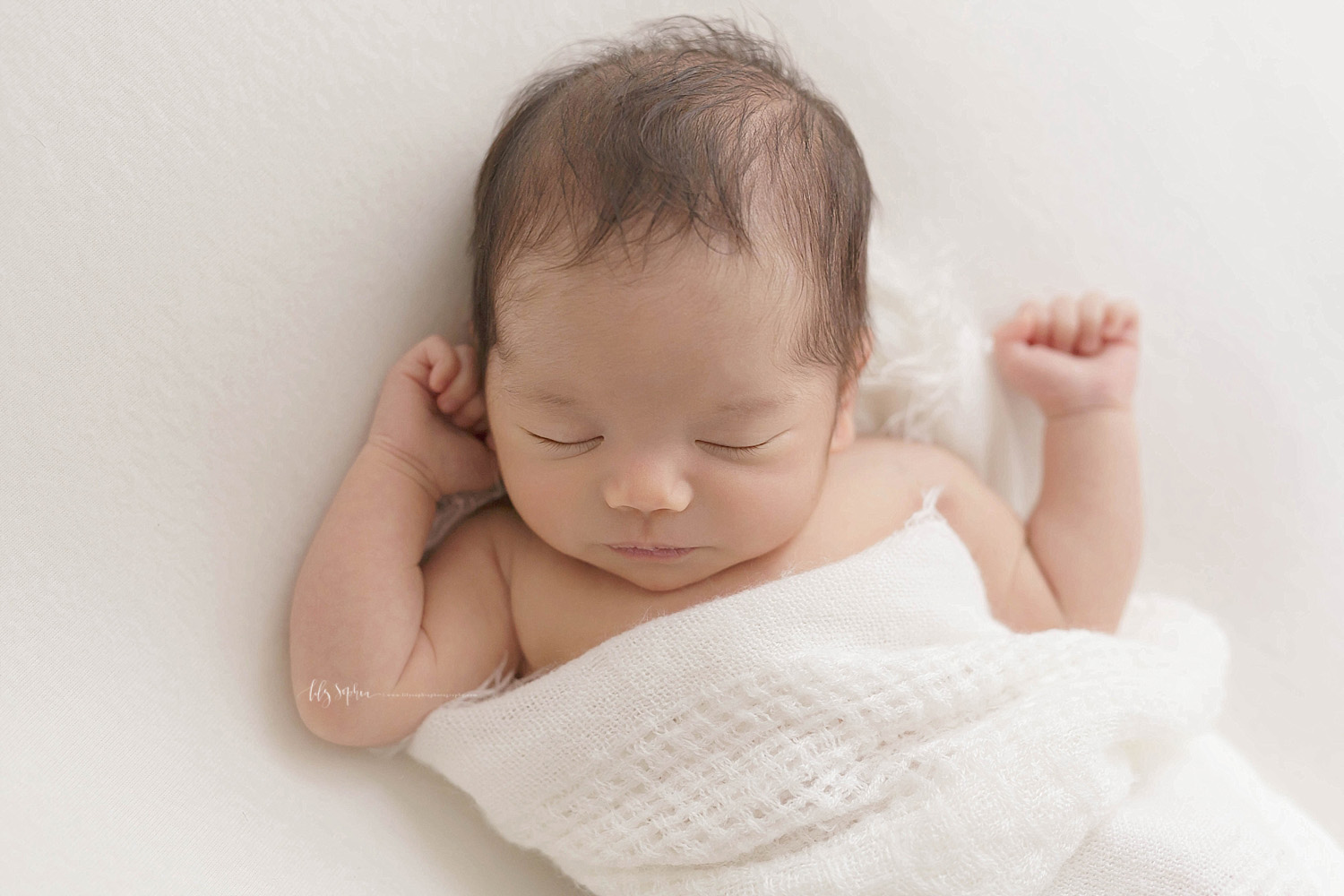  Image of a sleeping baby, Asian, newborn, girl, with her arms stretched out to her head.&nbsp; 