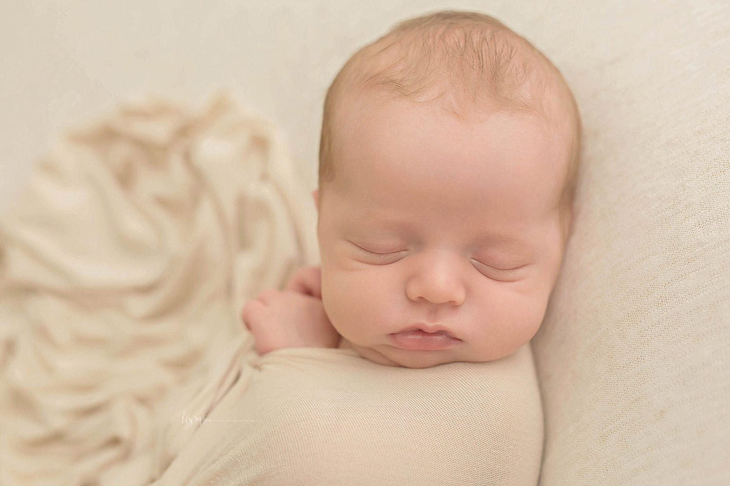  Image of a newborn, baby, boy, with chubby cheeks, sleeping on his back, wrapped up, with just his hands peeking out.&nbsp; 