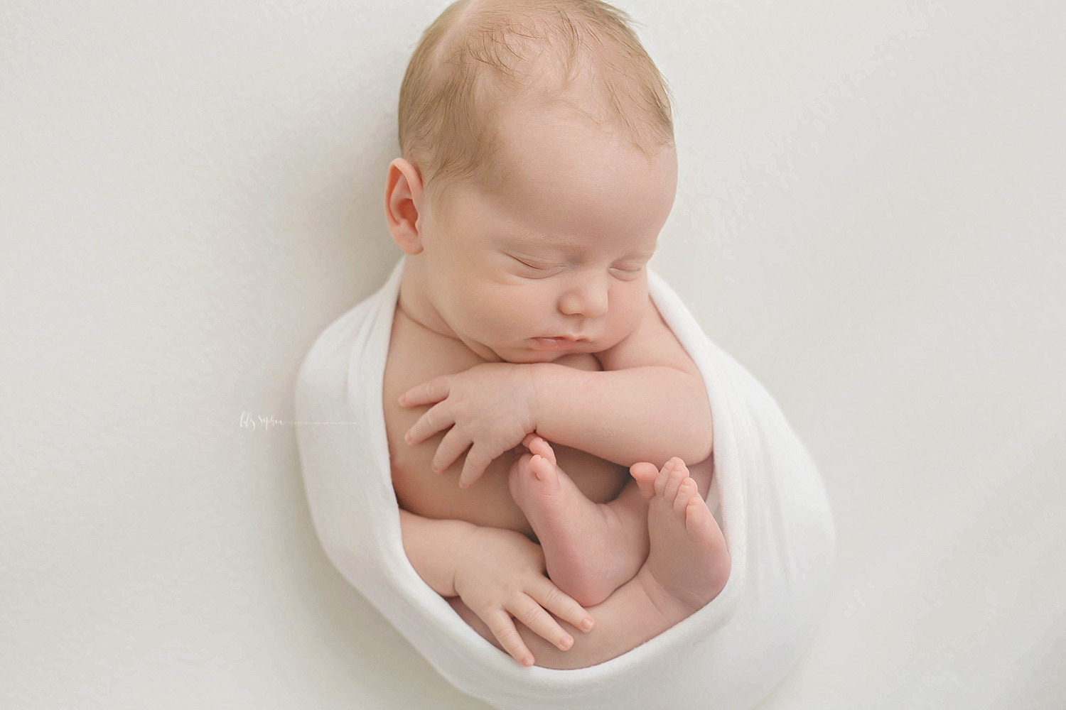  Image of a newborn, baby, boy, sleeping, wrapped in a the egg pose.&nbsp; 