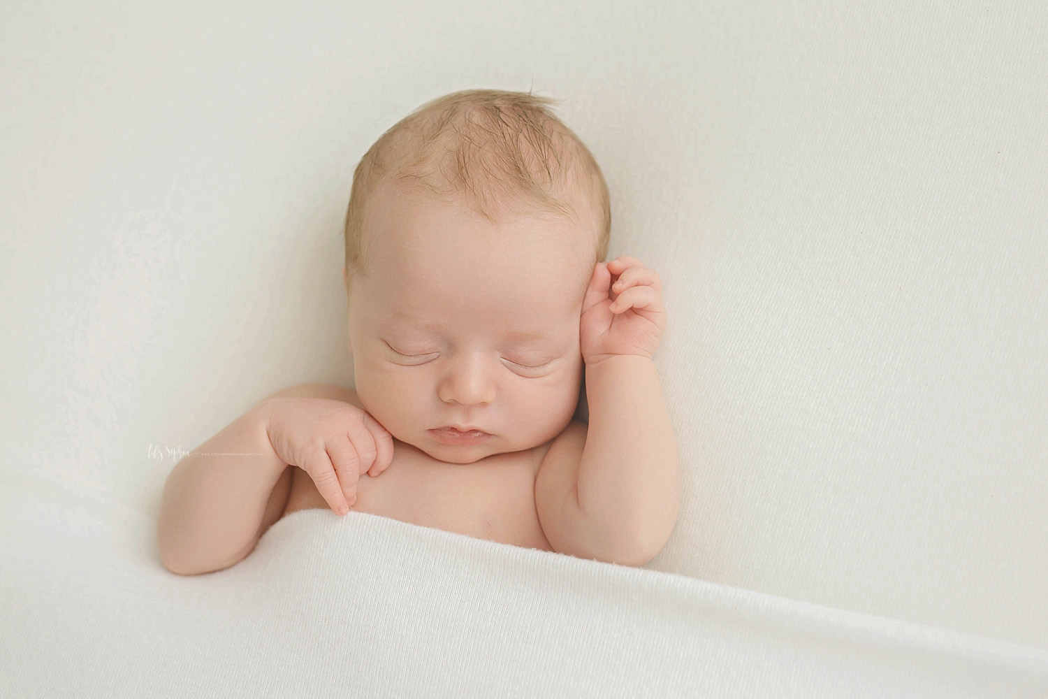  Image of a sleeping, baby, newborn, boy, on his back, with one hand on his chest and one hand up by his head.&nbsp; 