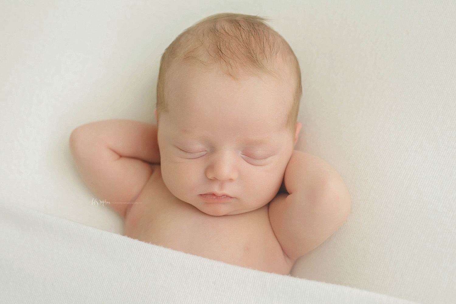  Image of a sleeping, newborn, baby, boy, on his back, with his hands behind his head.&nbsp; 