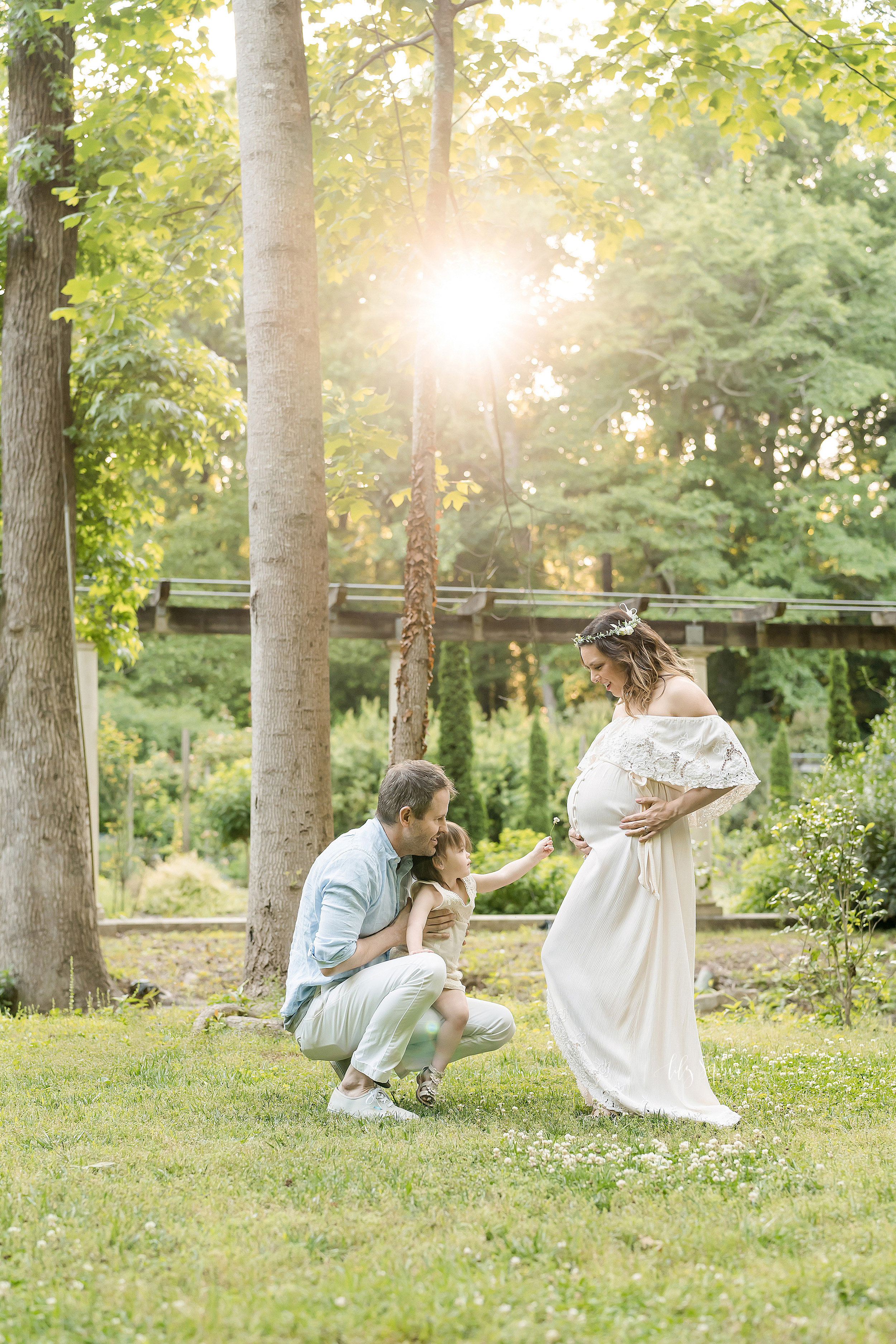  Family photo of three interacting at sunset in an Atlanta garden. 