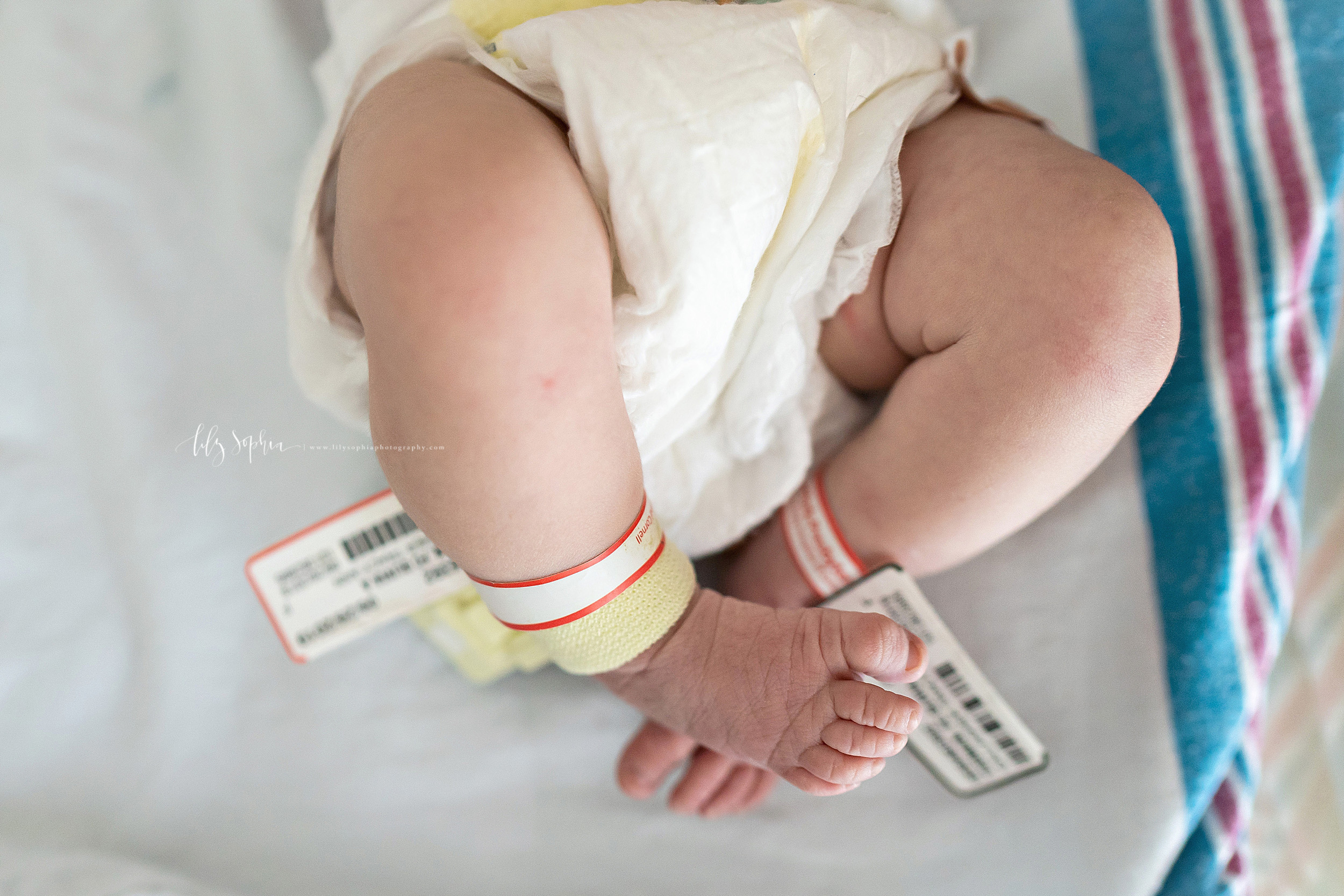  Photo of the a precious newborn baby girl’s legs and feet as she sits in her bassinet in a Lenox Hill hospital. 