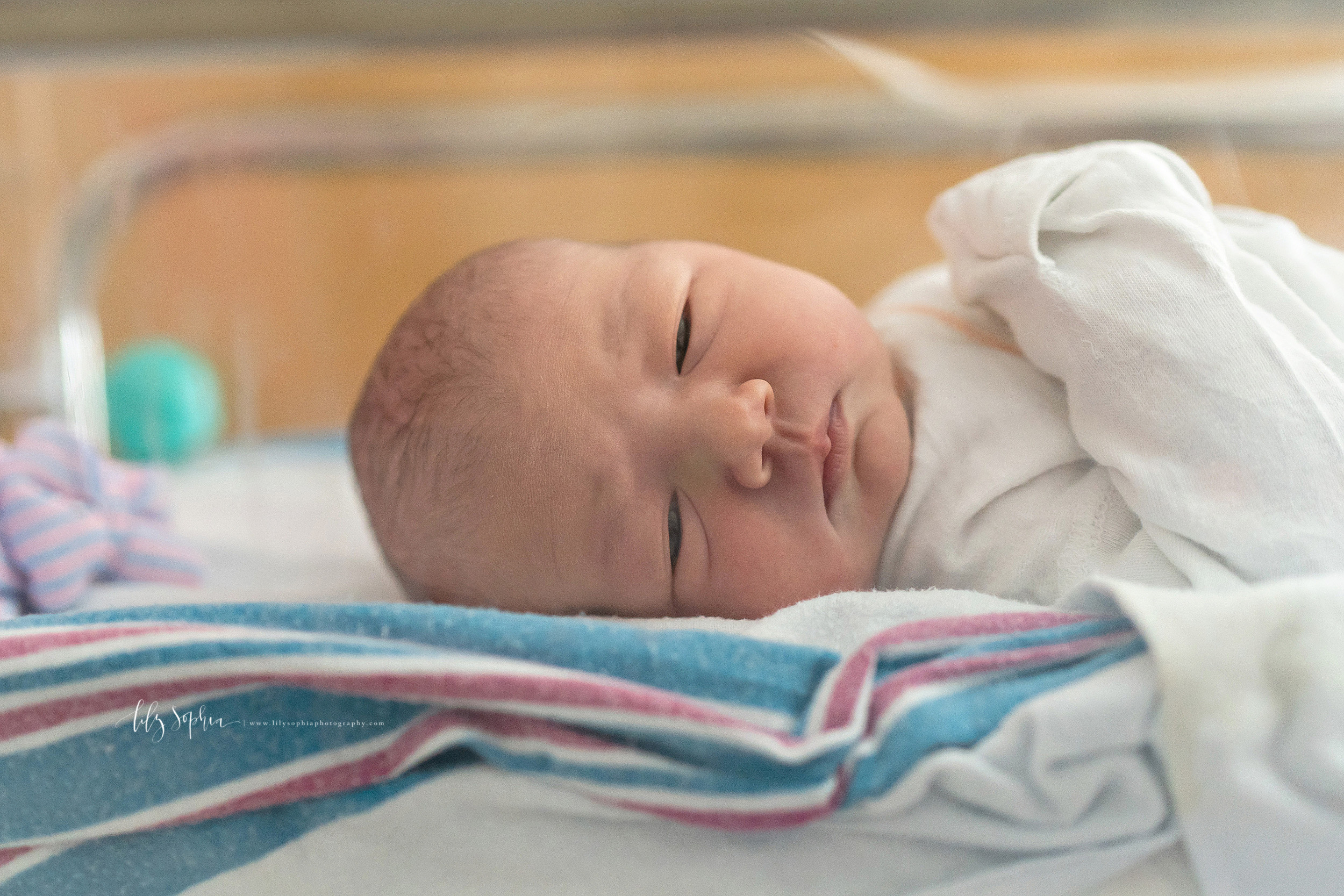  Photo of an awake newborn as she looks out of her bassinet in the hospital in Manhattan. 